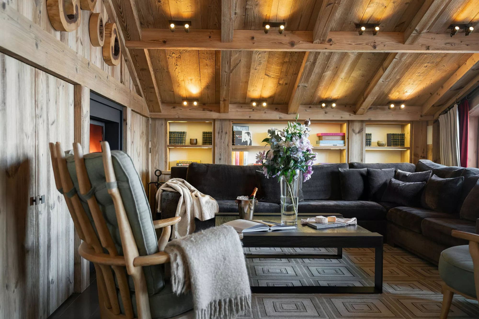 Living room with a wood-burning fireplace and timber-clad walls