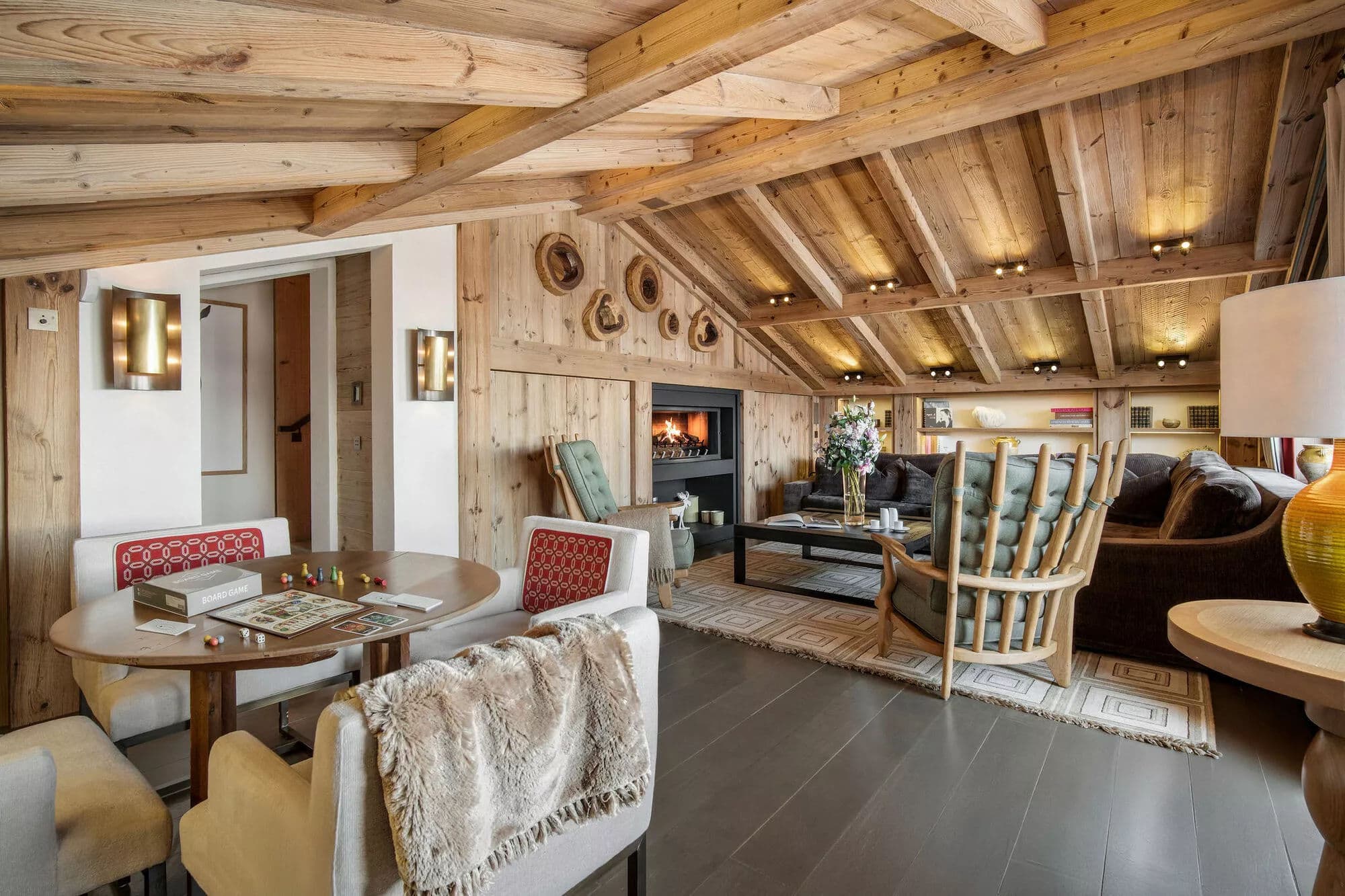 Open-plan living area with sectional seating and a timber-beamed ceiling