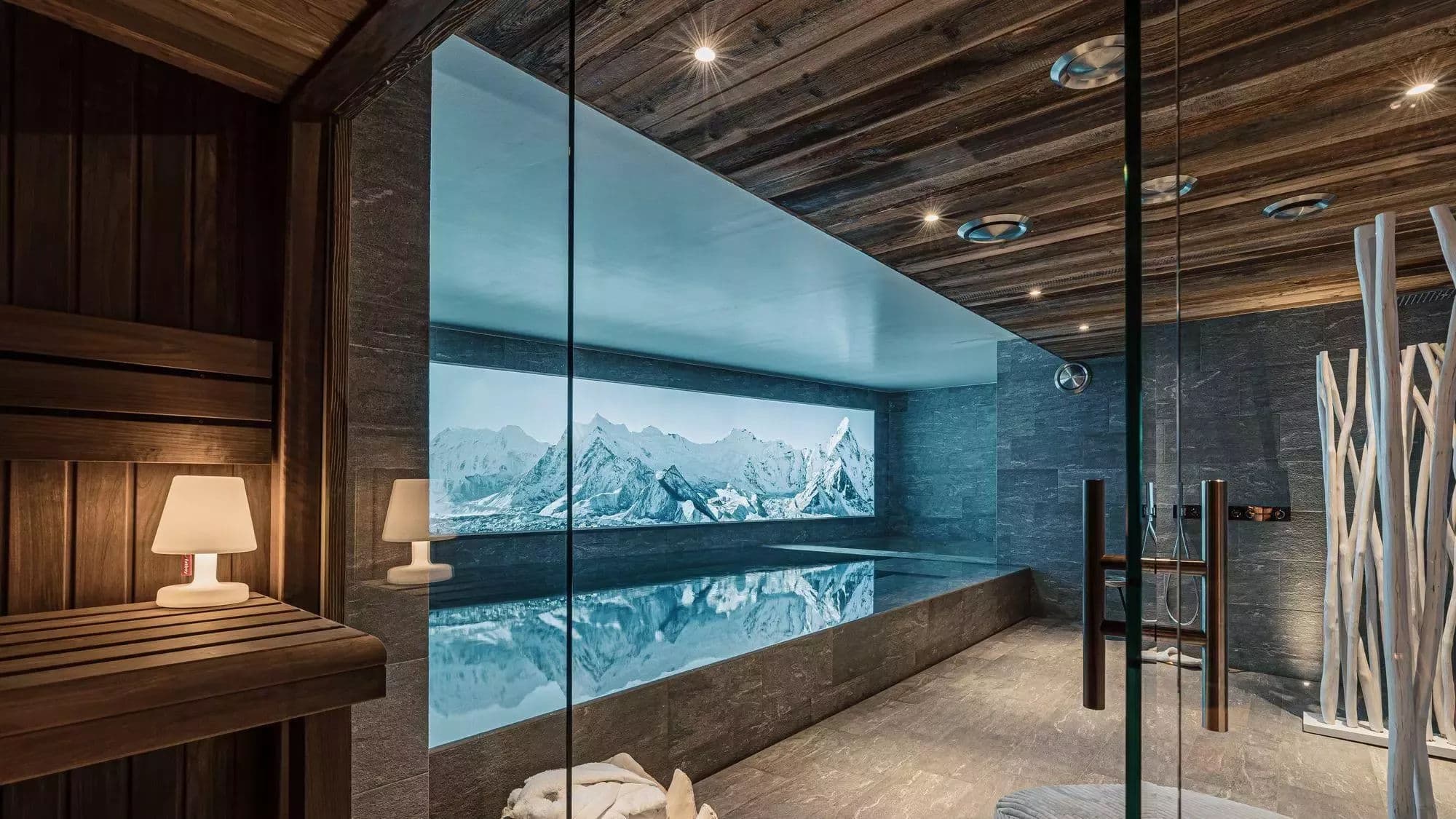 Indoor pool viewed through the glass-fronted sauna in the wellness area