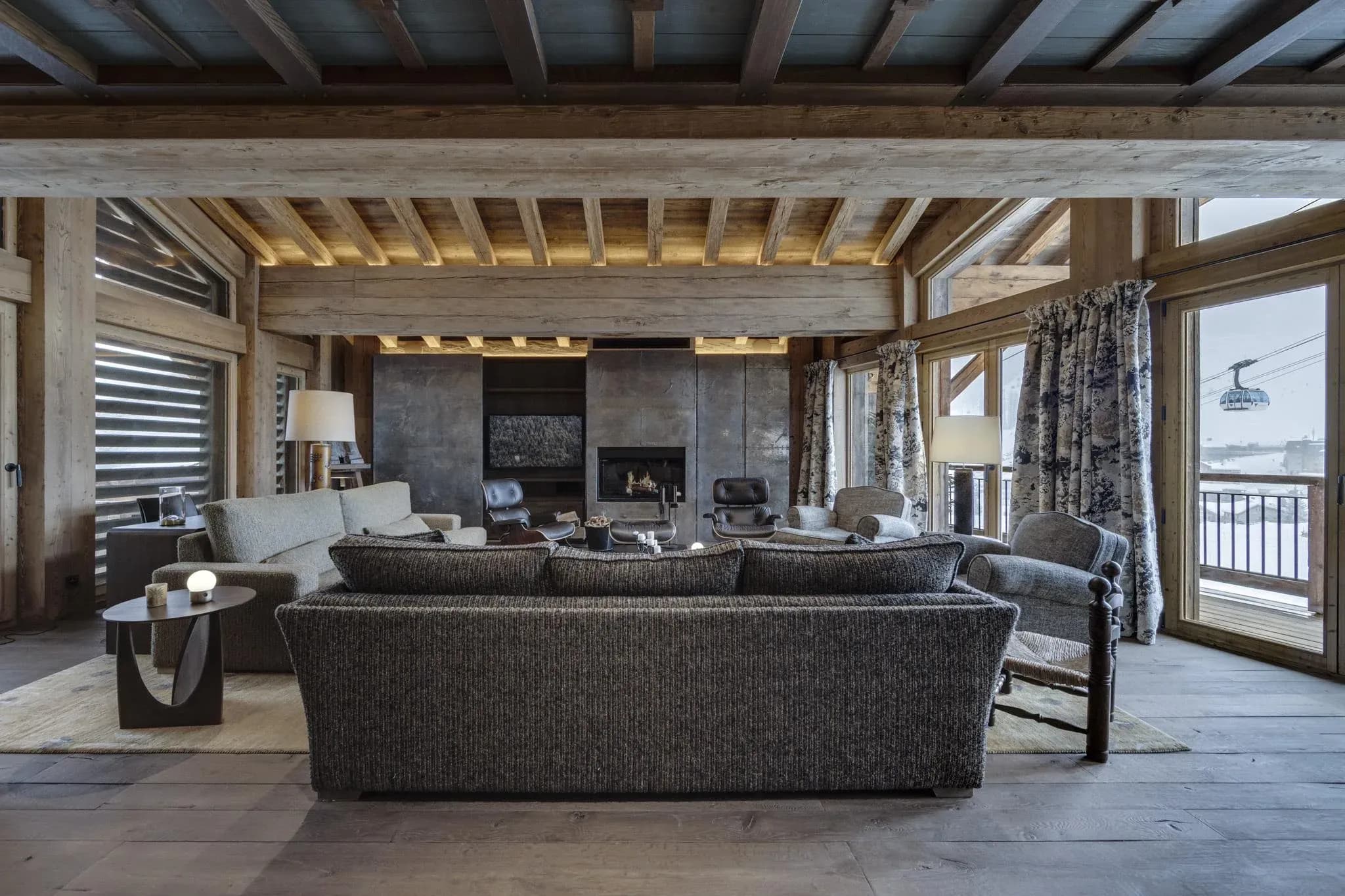 Living room with fireplace, two sofas and balcony doors facing the gondola