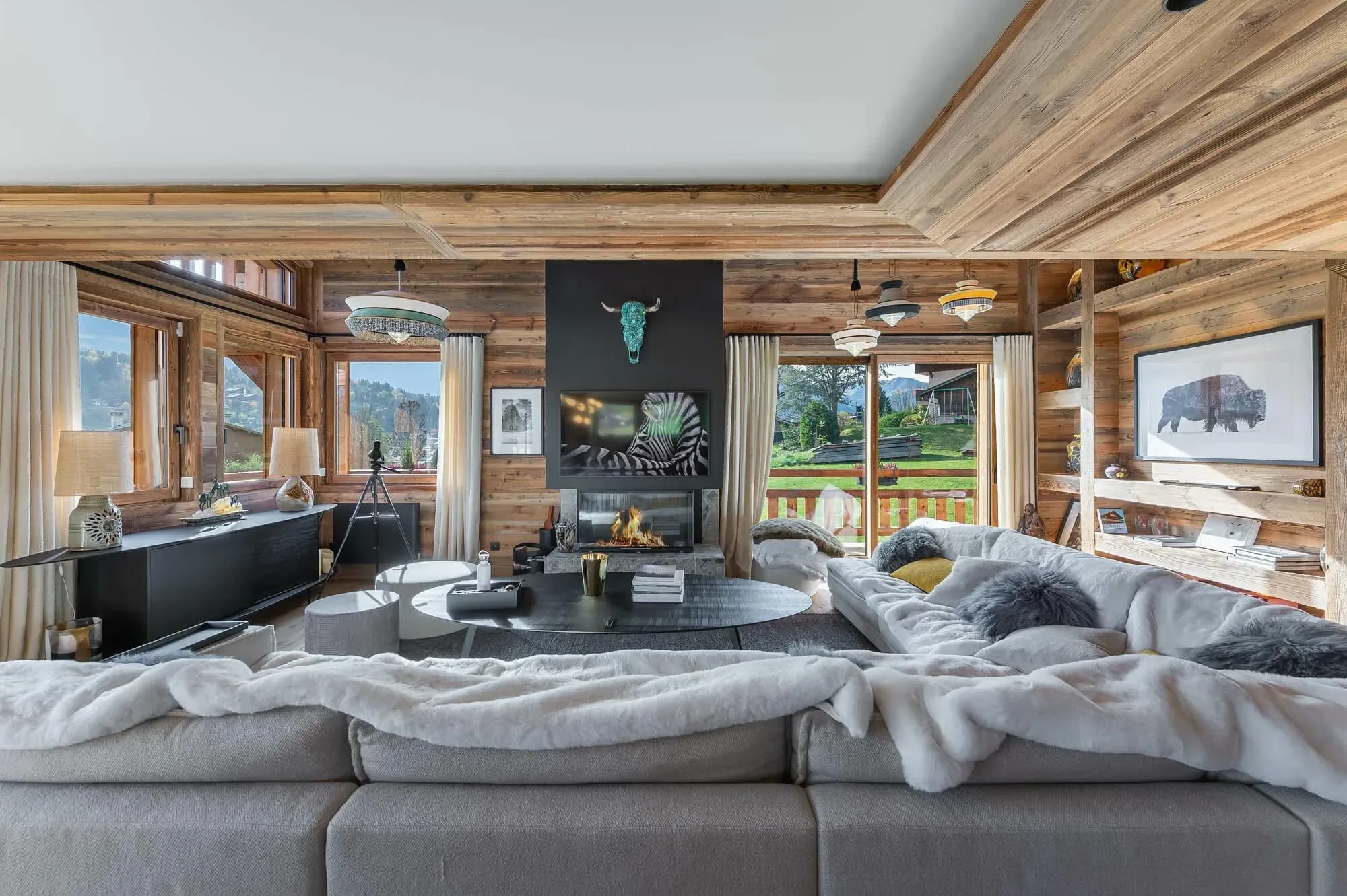 Living room with corner sofa, wood-burning fireplace and TV above