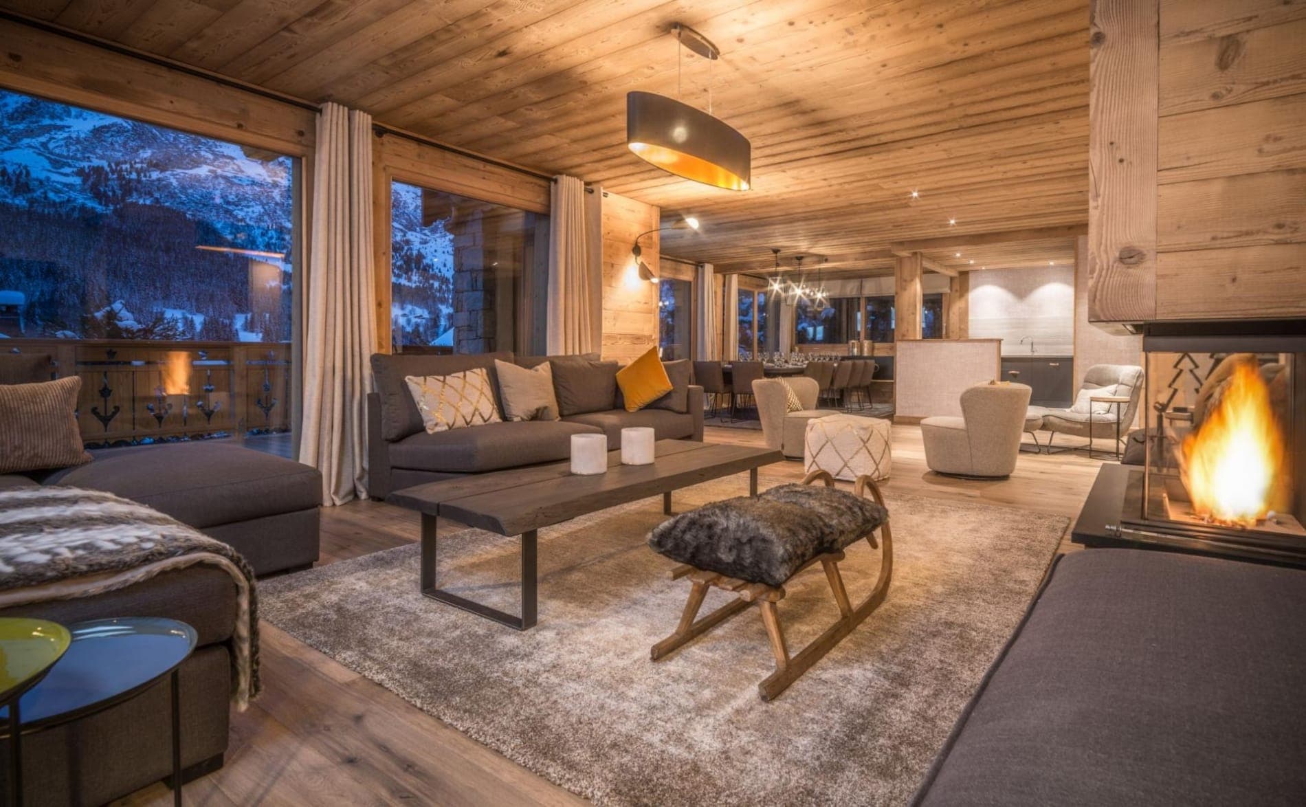 Open-plan living room with fireplace and mountain views