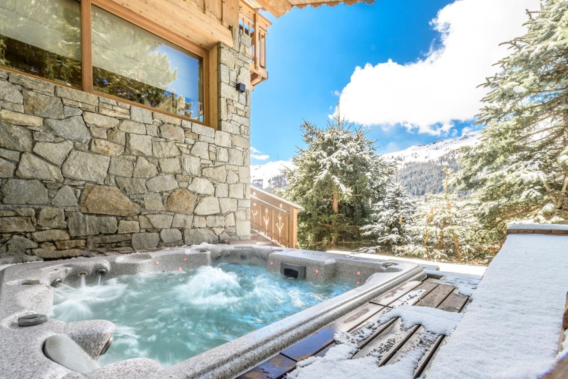 Outdoor hot tub with snowy mountain views