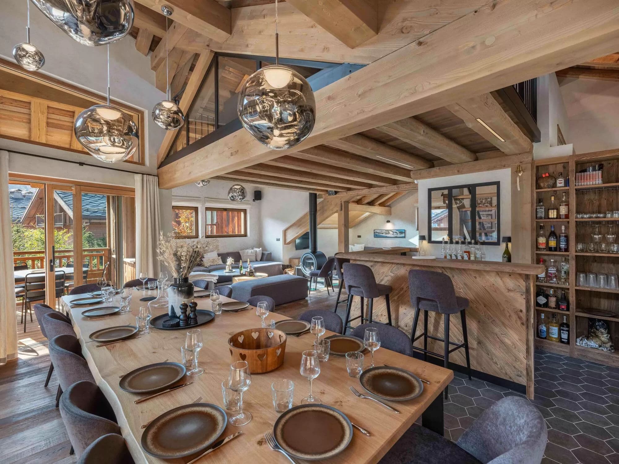 Dining table for 14 beside the open kitchen and bar