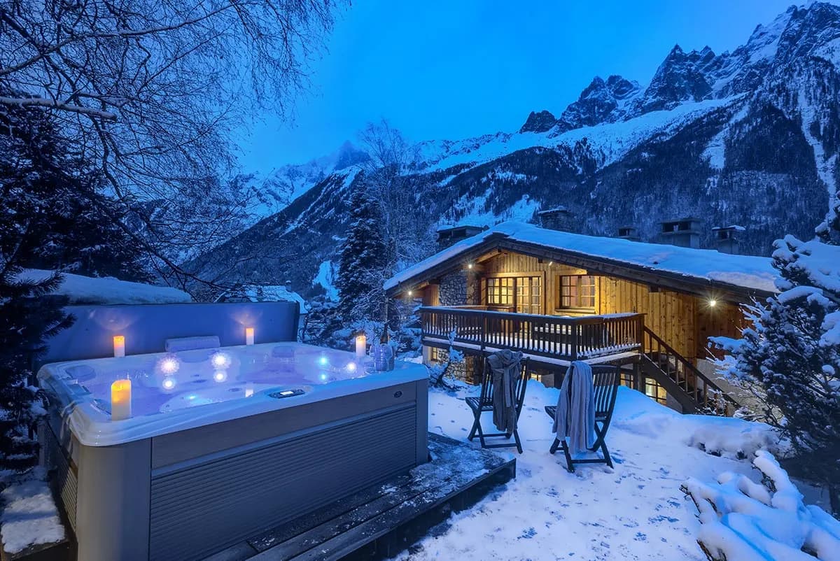 Chalet and outdoor hot tub at dusk