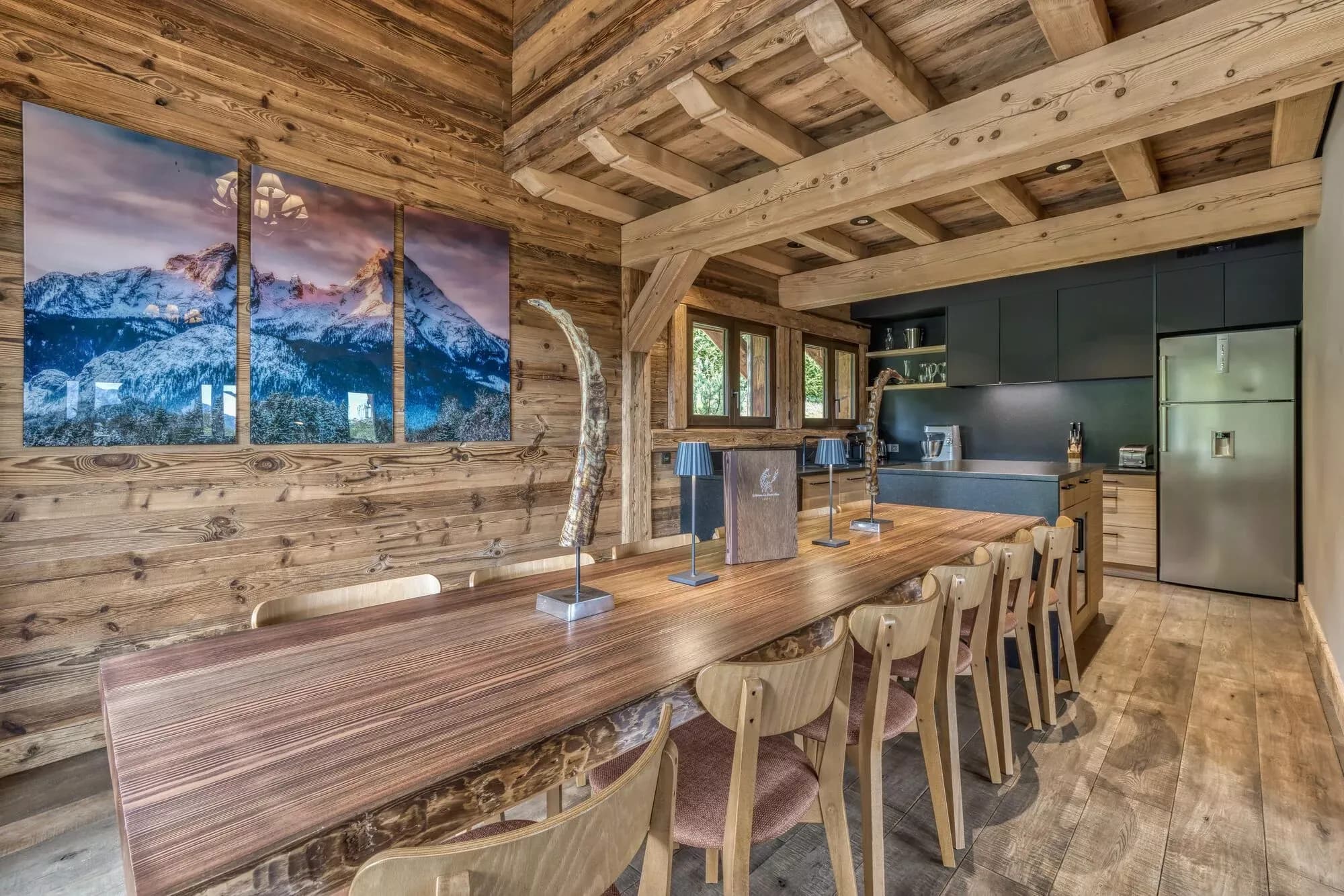 Dining area and open fitted kitchen beneath timber beams