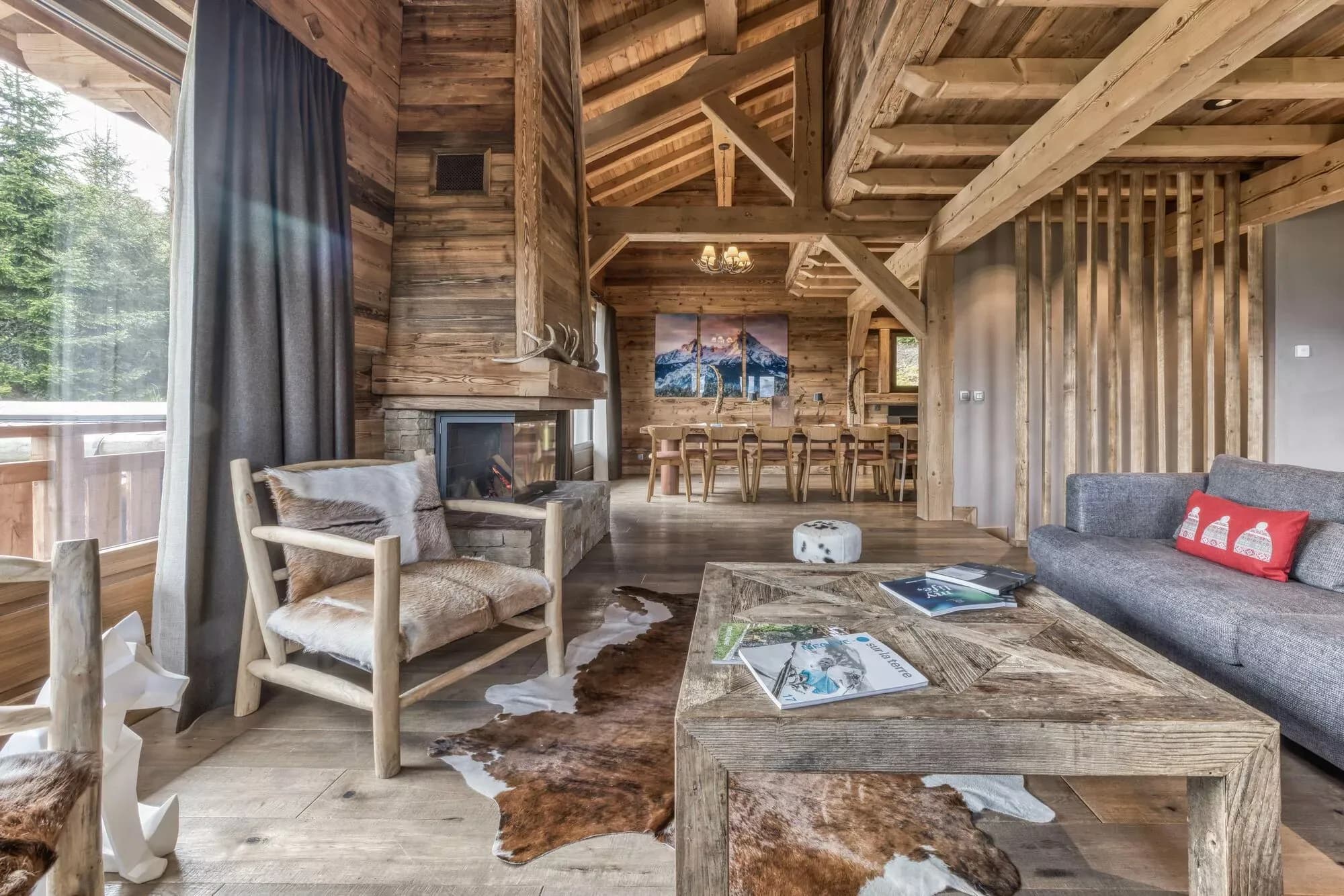 Open-plan living room with timber beams, lounge seating and fireplace