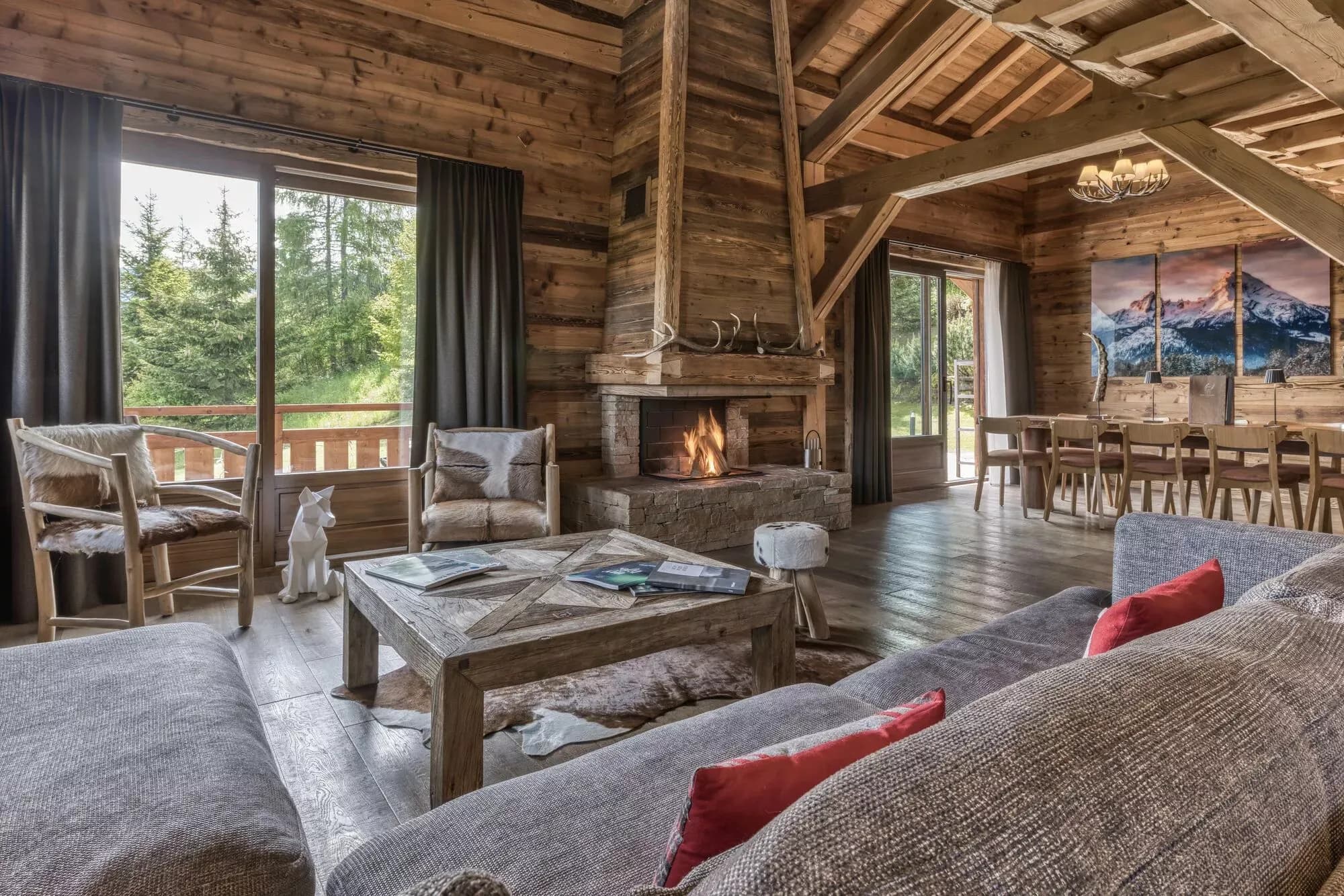 Living and dining area centred on a stone fireplace