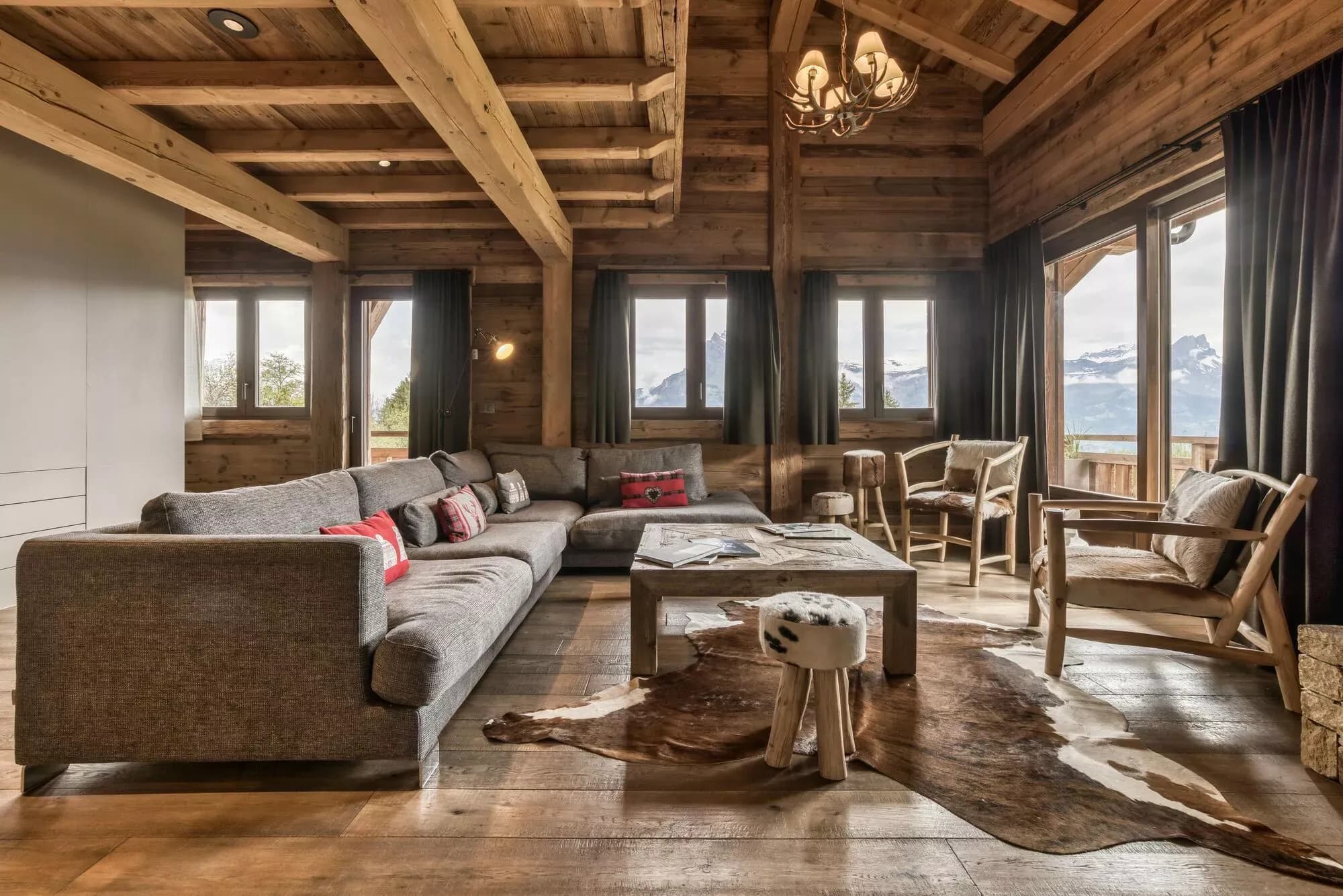 Lounge seating beside broad windows and the fireplace