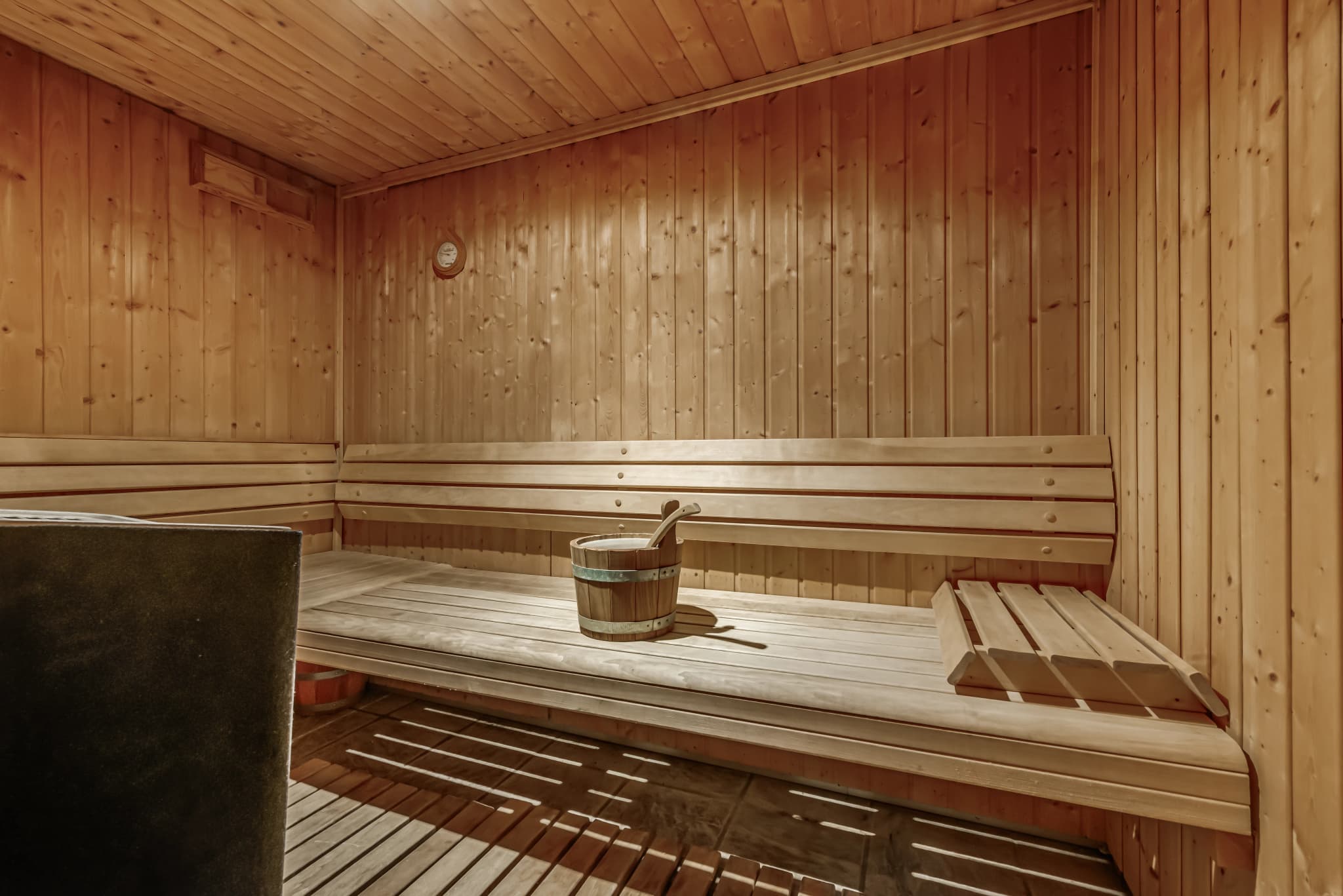 Sauna with timber benches and heater