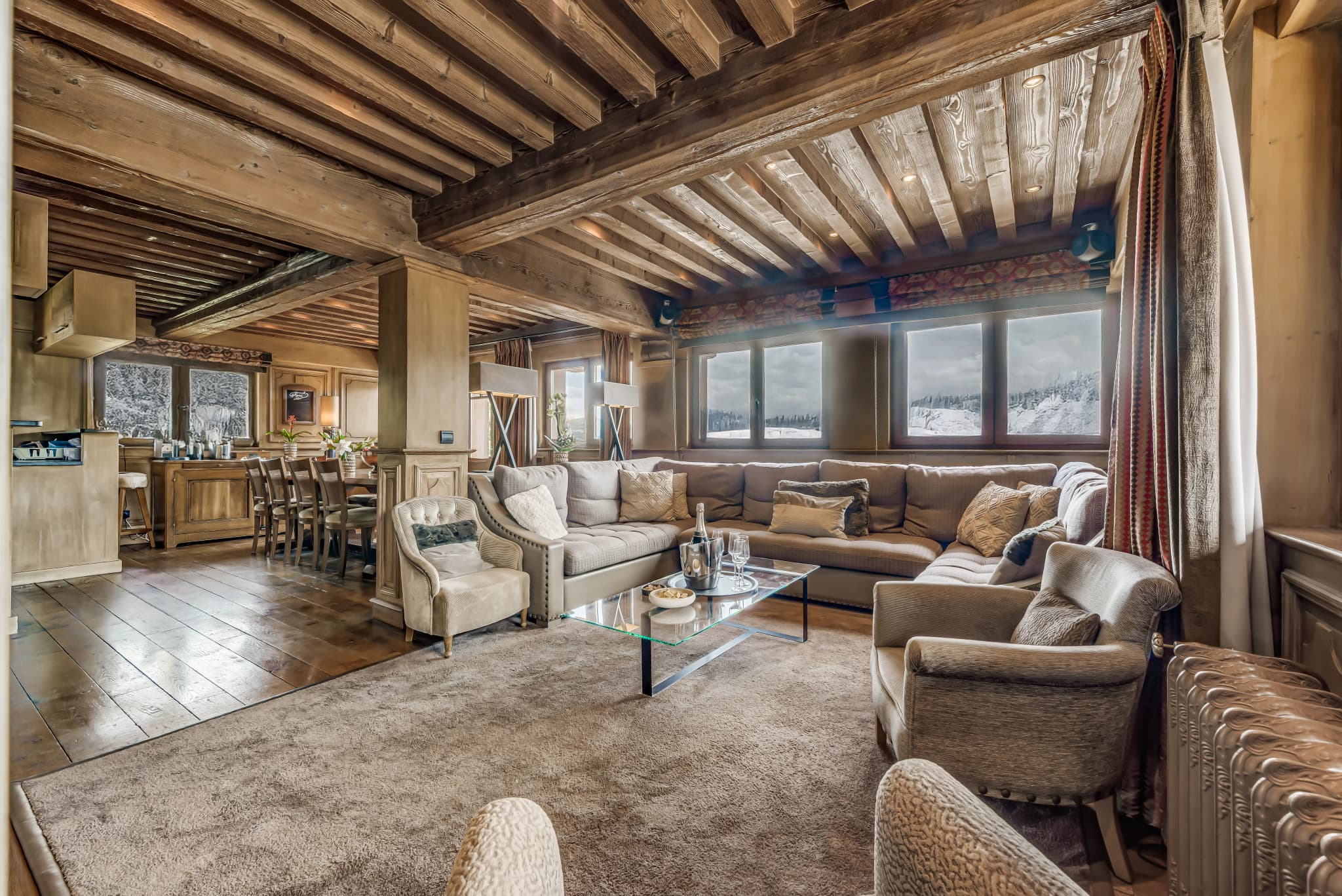 Living room with timber beams and mountain-facing windows