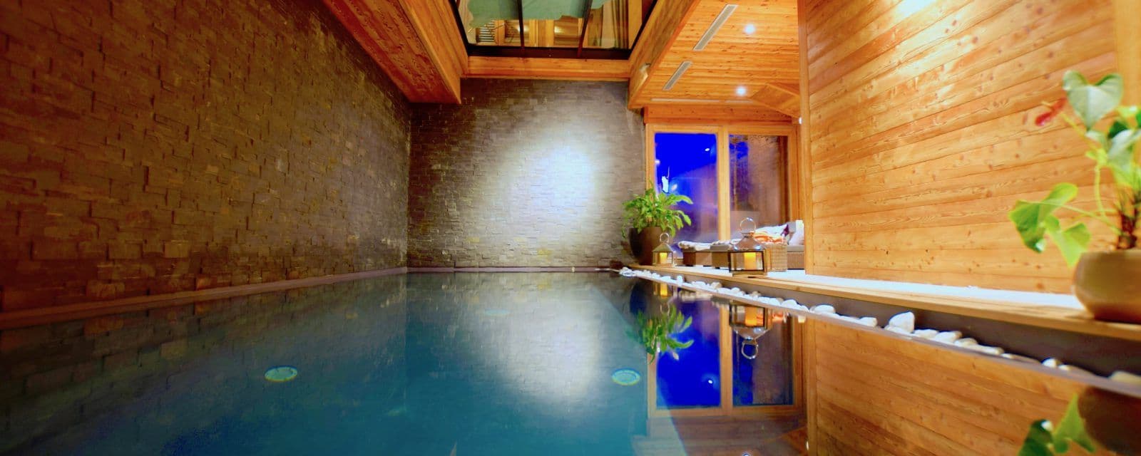 Indoor swimming pool with timber-lined poolside seating