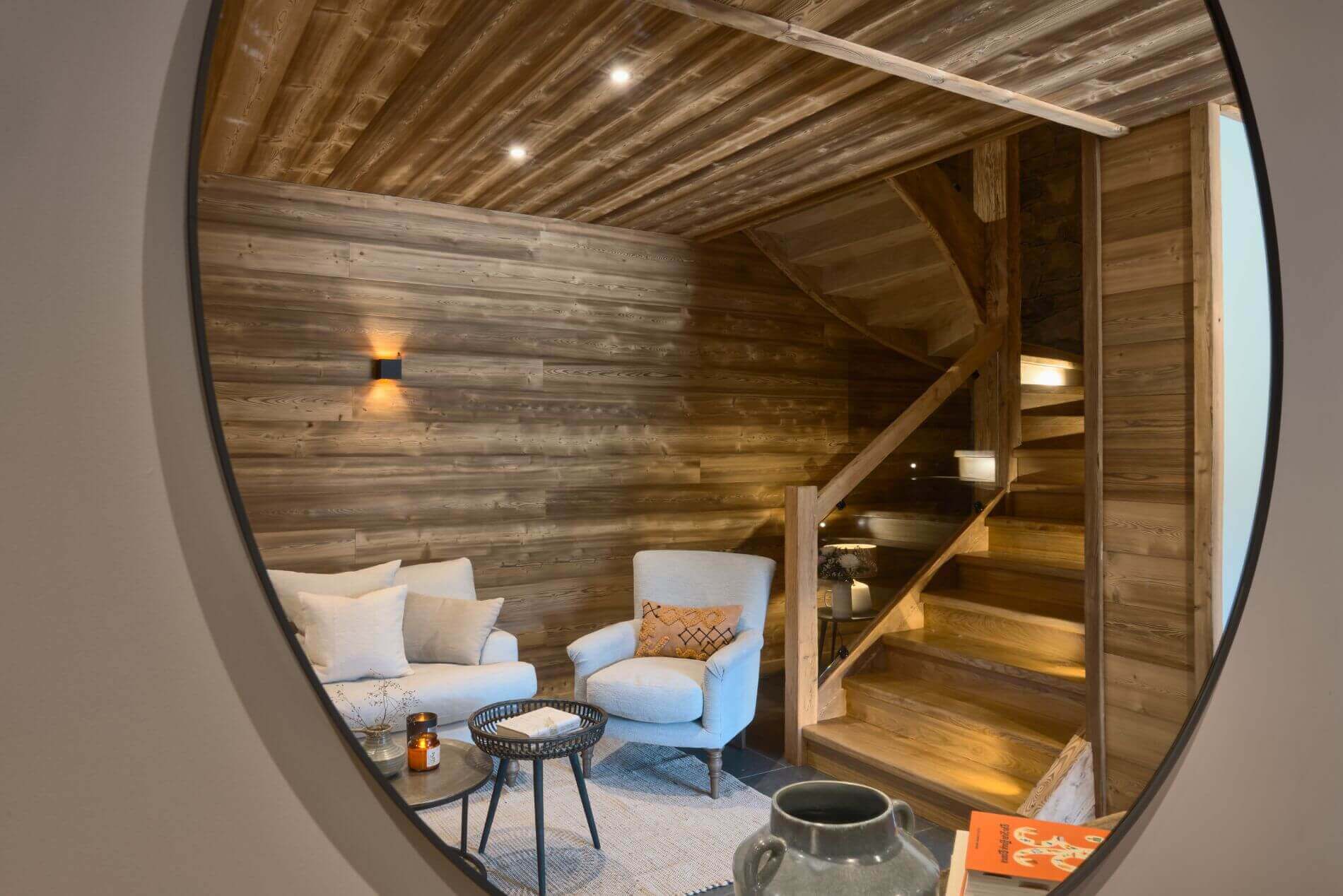 Wood-panelled hallway reflected in a large circular mirror