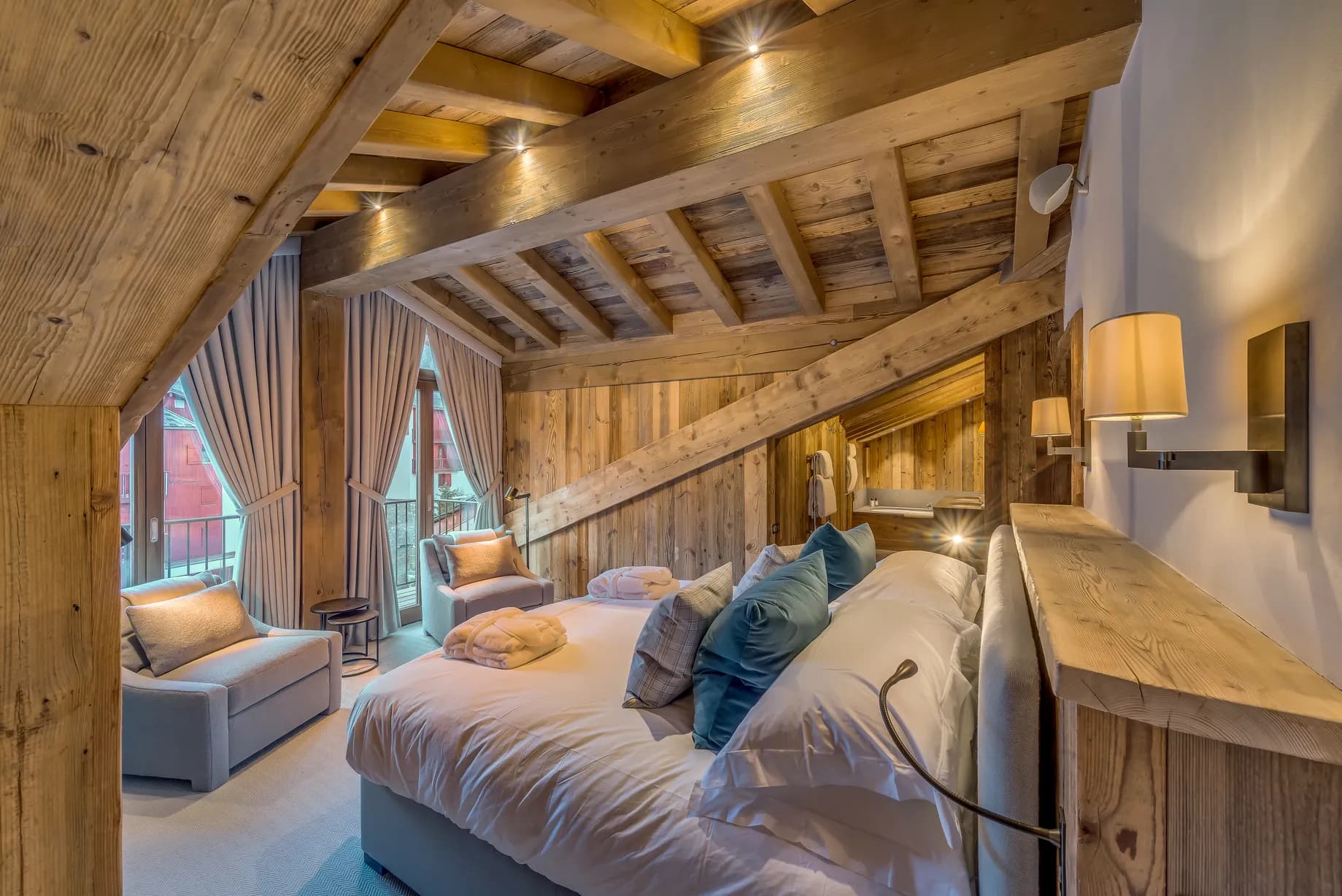 Double bedroom beneath a sloping timber ceiling