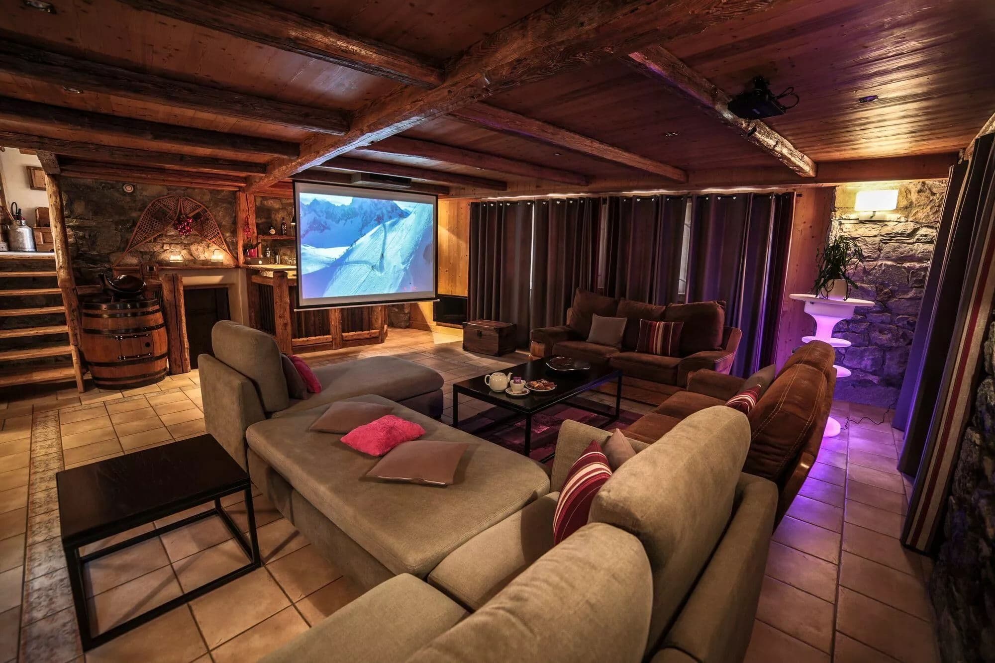 Television lounge with sofas beneath a timber ceiling