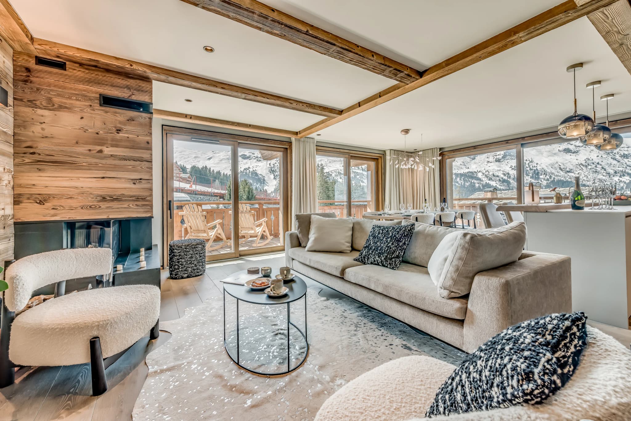 Lounge with fireplace and mountain-facing windows