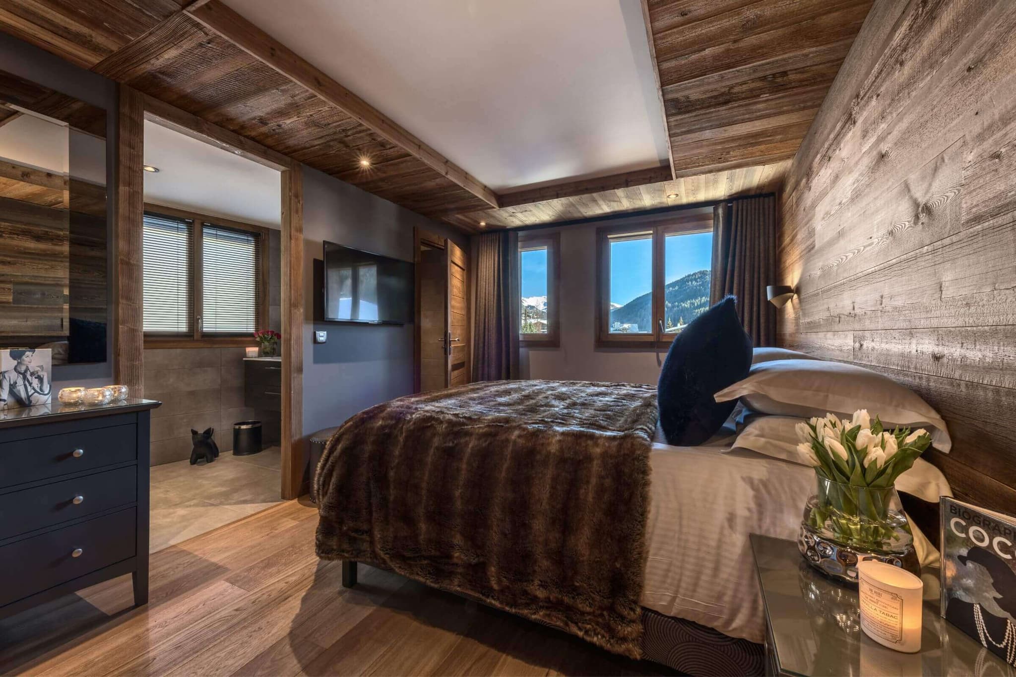 King bedroom with timber detailing and mountain views