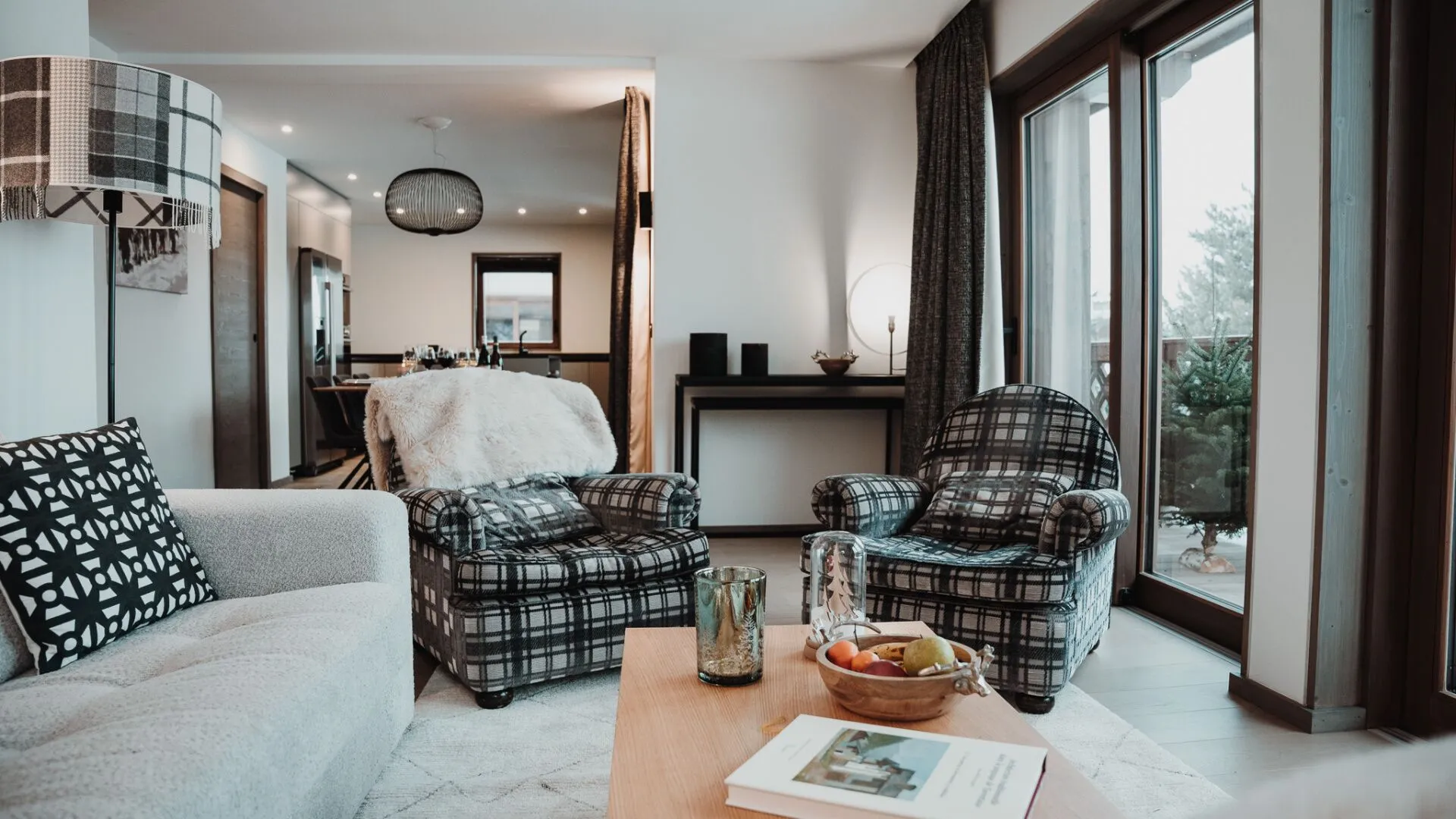 Open-plan living area with plaid armchairs