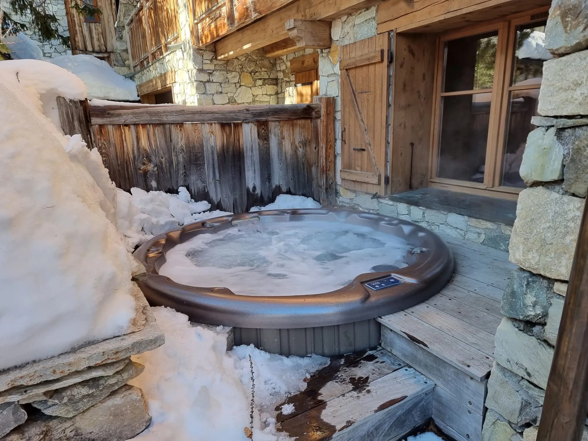 Private outdoor hot tub beside the terrace