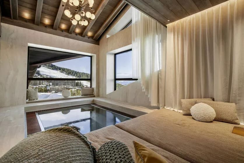 Indoor Jacuzzi beside a relaxation area and panoramic windows