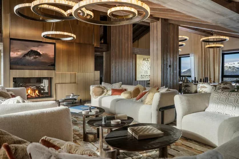 Penthouse living room with panoramic windows, lounge seating and a fireplace