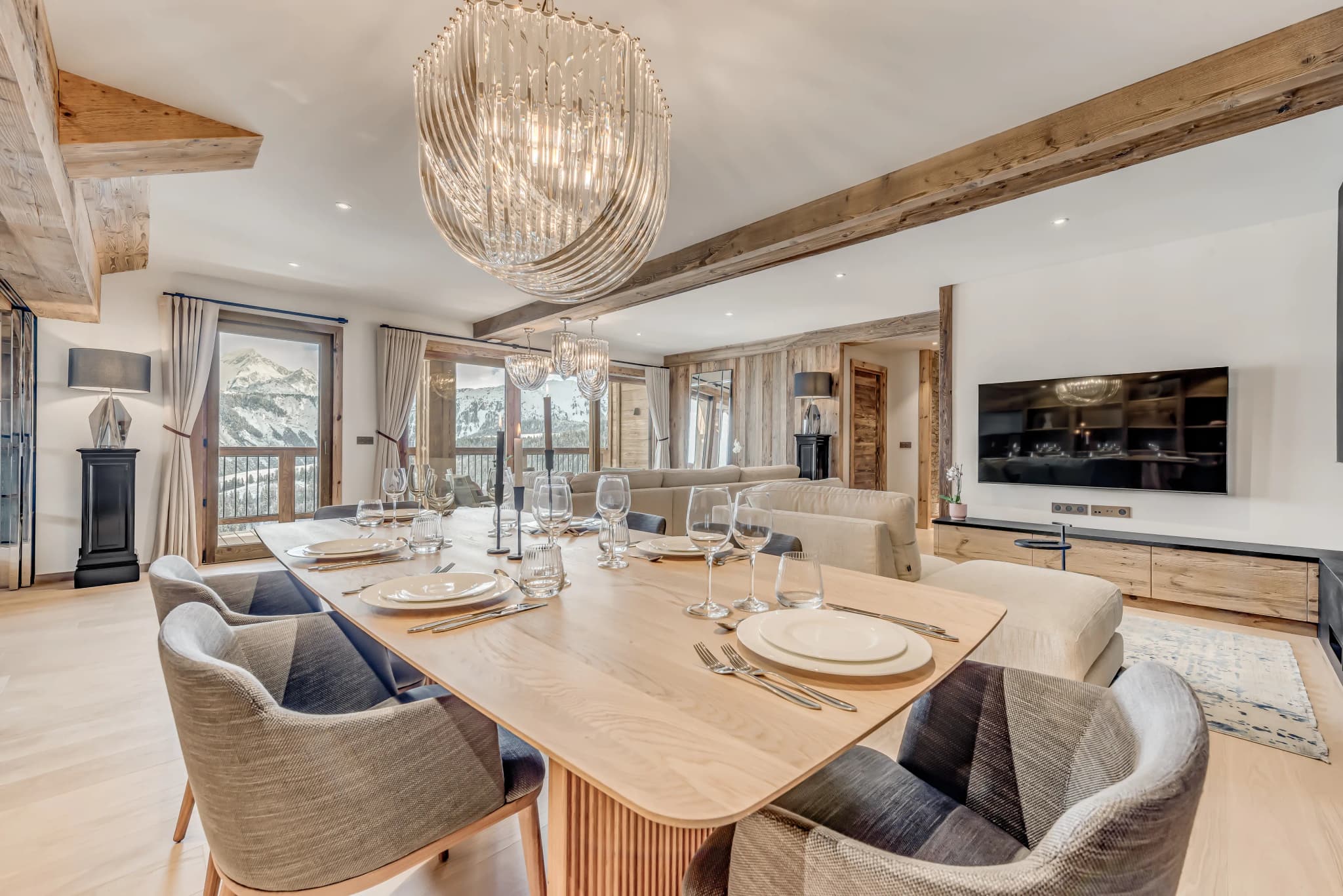 Dining table beside the open-plan kitchen and lounge