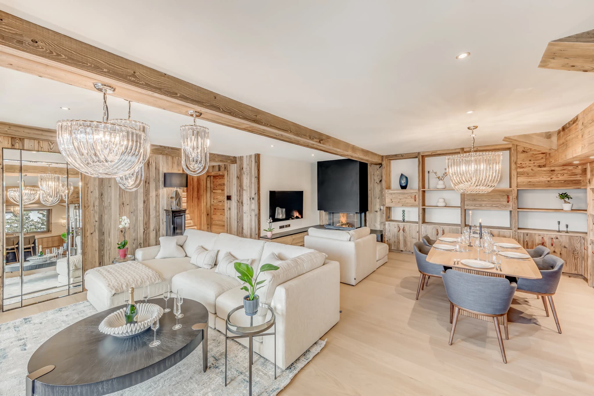 Open-plan lounge and dining area beneath timber beams