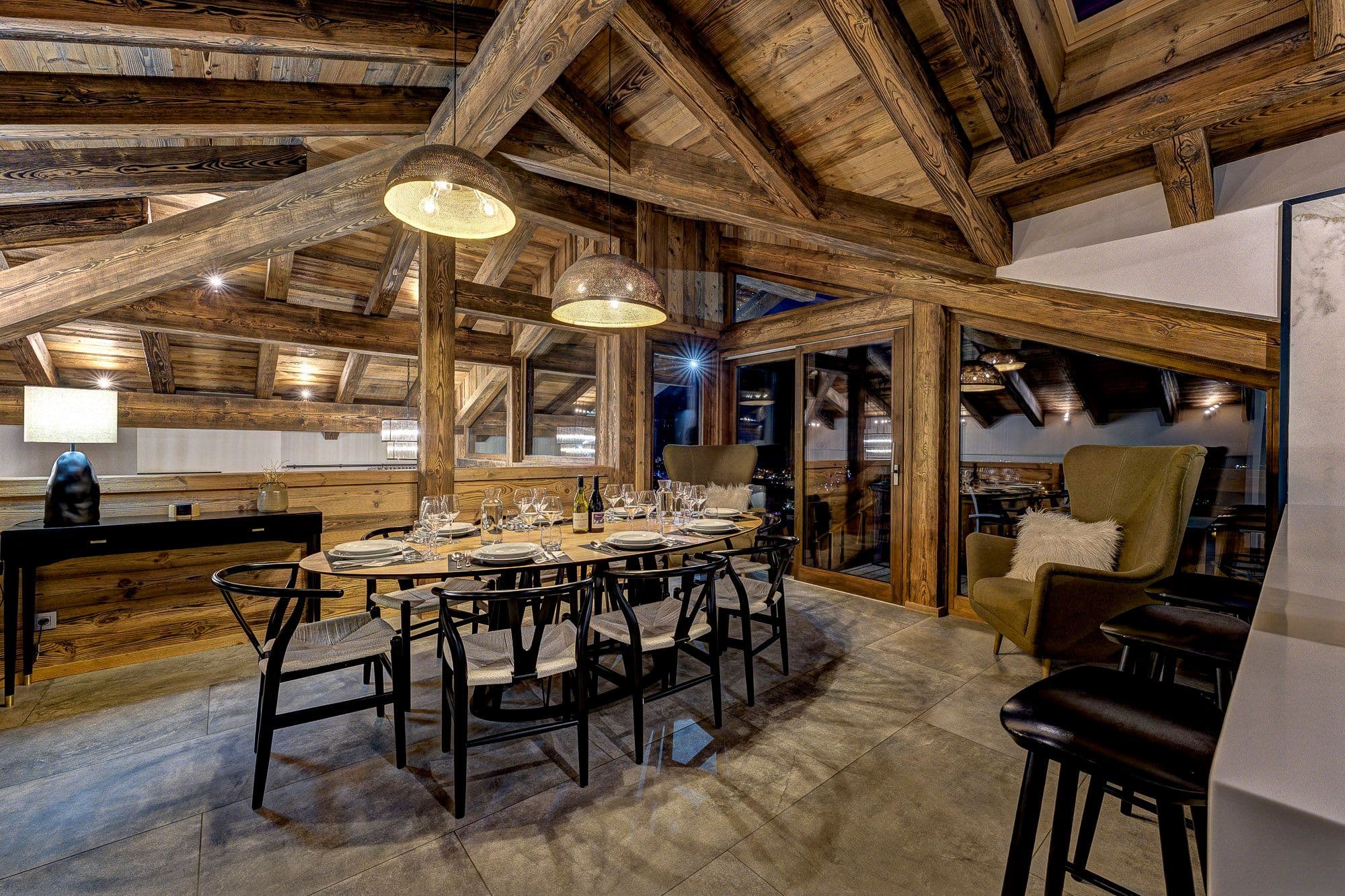 Open-plan dining area beneath a vaulted timber ceiling