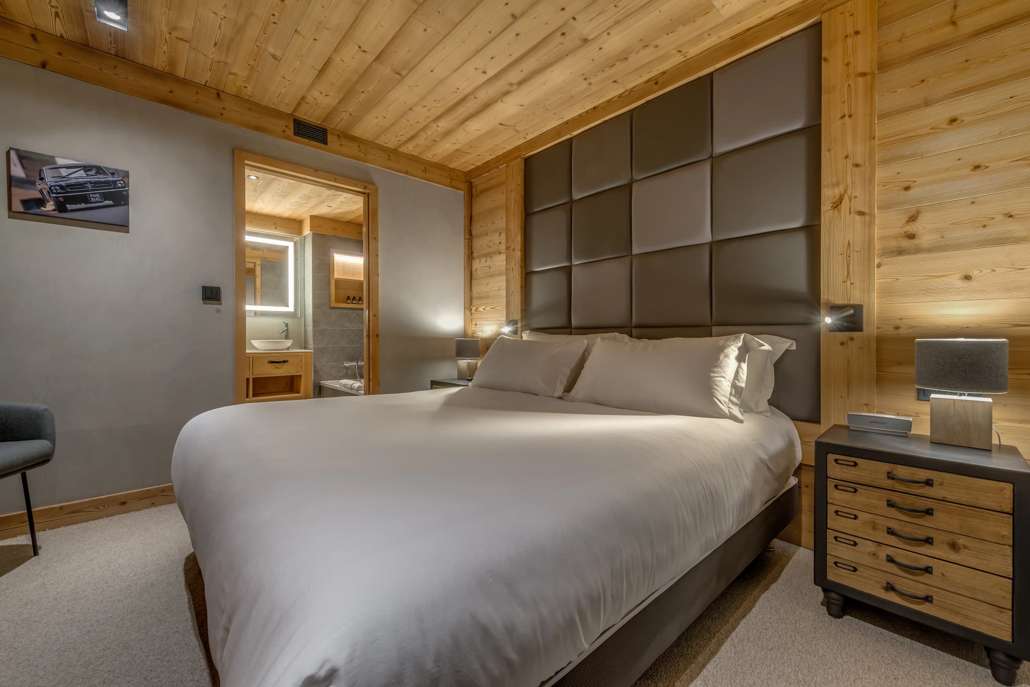 Double bedroom with timber finishes and a padded headboard