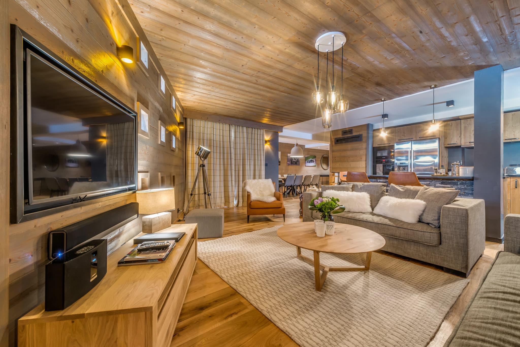 Open-plan lounge with timber finishes and a television