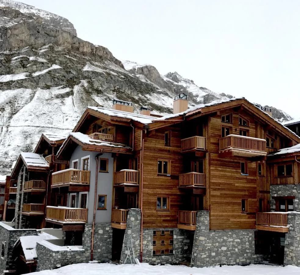 Timber residence set below the snowy mountains