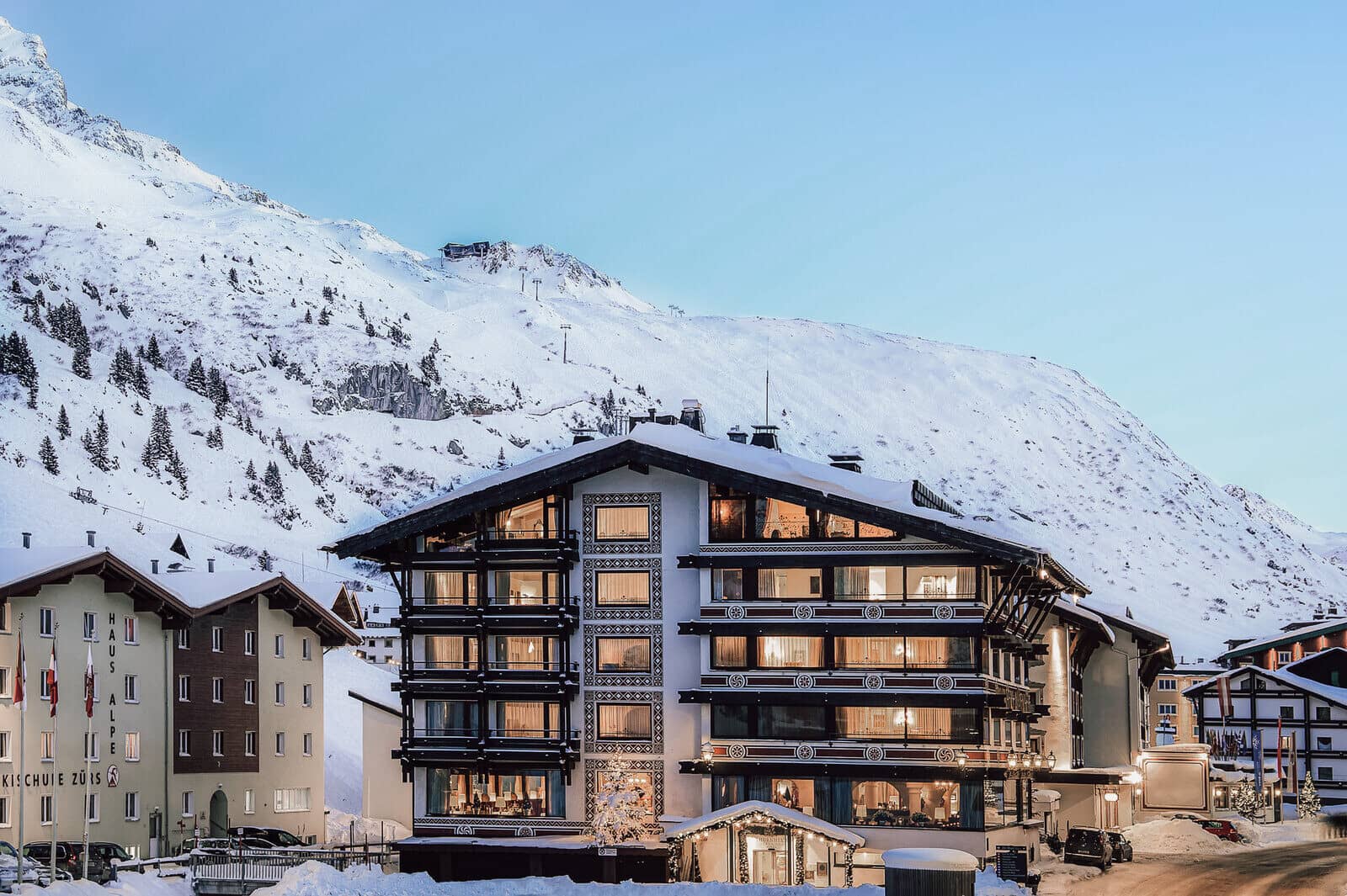 Ski-in lodge exterior with private balconies and direct mountain access