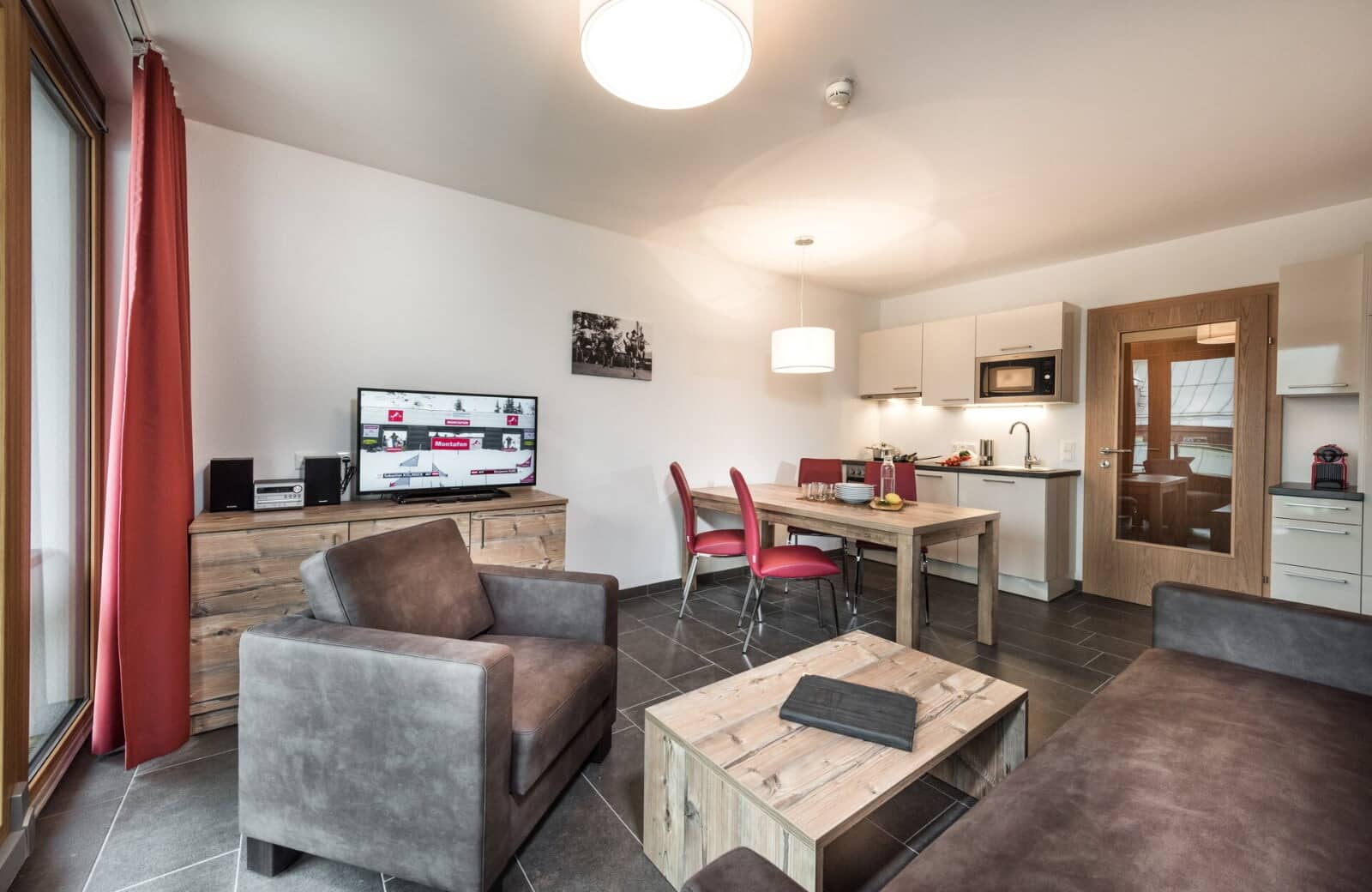 Open-plan living area with dining table for 4 and kitchenette