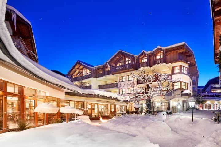 Ski-in/ski-out lodge exterior with snow-covered courtyard and heated dining terrace