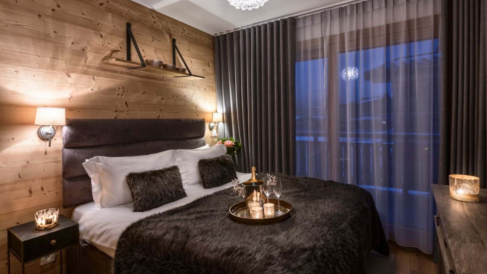 Double bedroom with timber panelling and terrace access