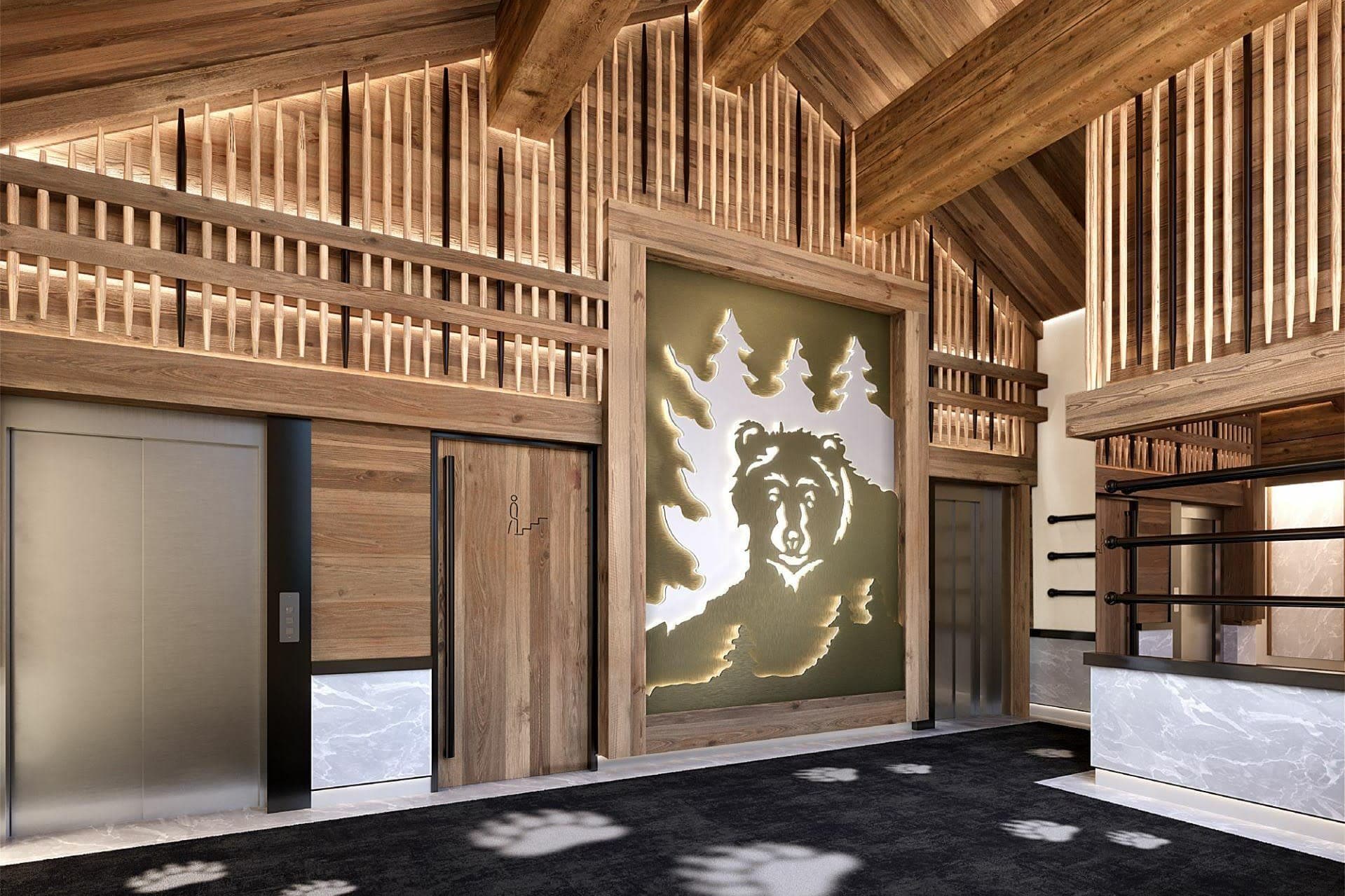 Wood-lined residence lobby with lift and ski storage