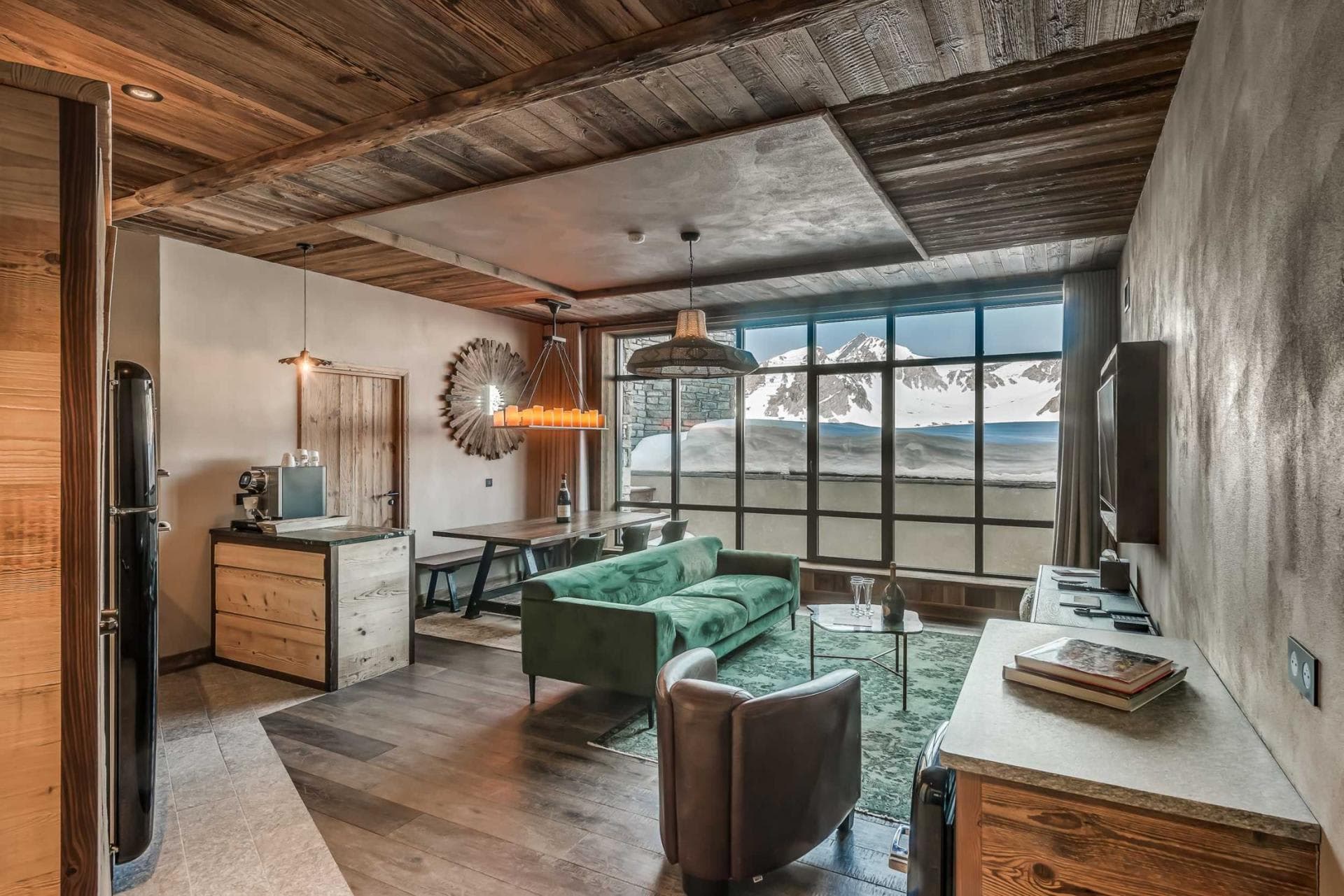 Open-plan living area with coffee station and mountain peak views