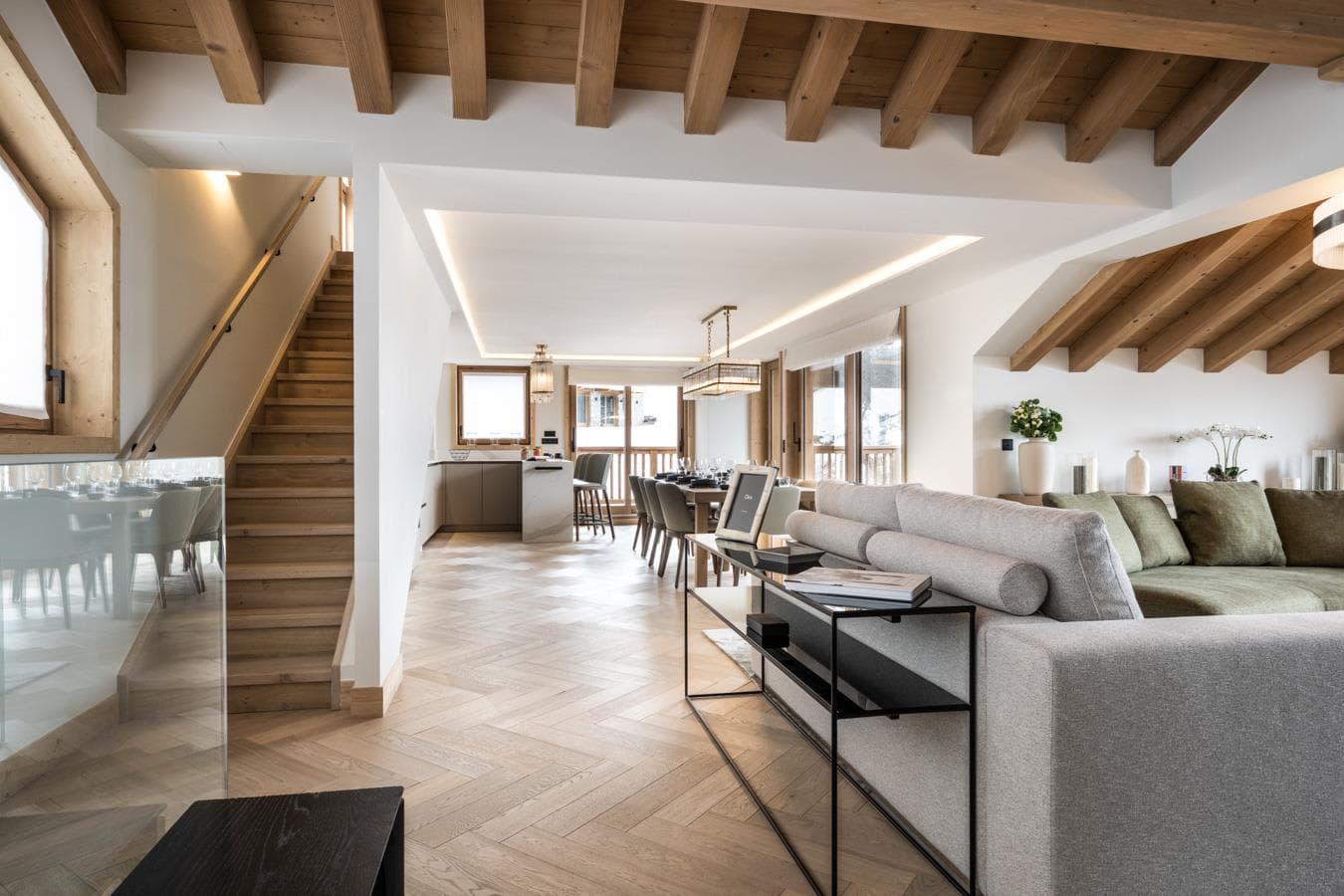 Open-plan living area with dining for 10 and herringbone floors