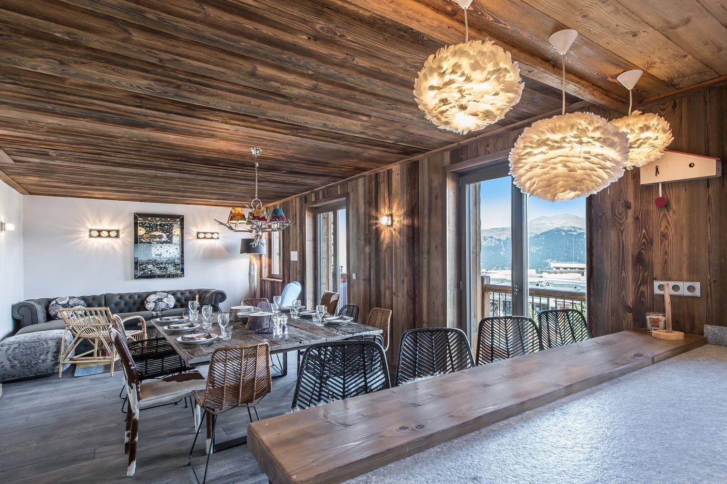 Open-plan living and dining area with balcony access and mountain views