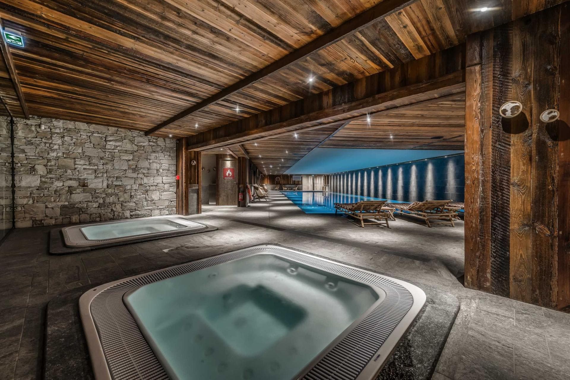 Indoor spa area with dual hot tubs and lap pool