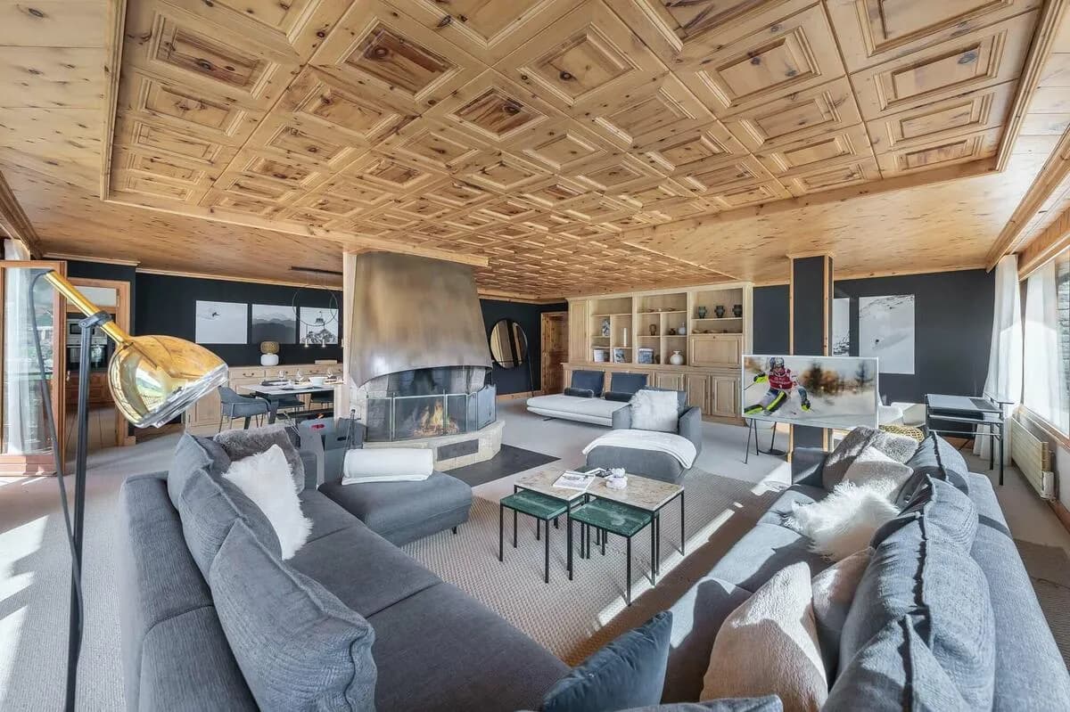 Living room with coffered wood ceiling, fireplace and mountain views