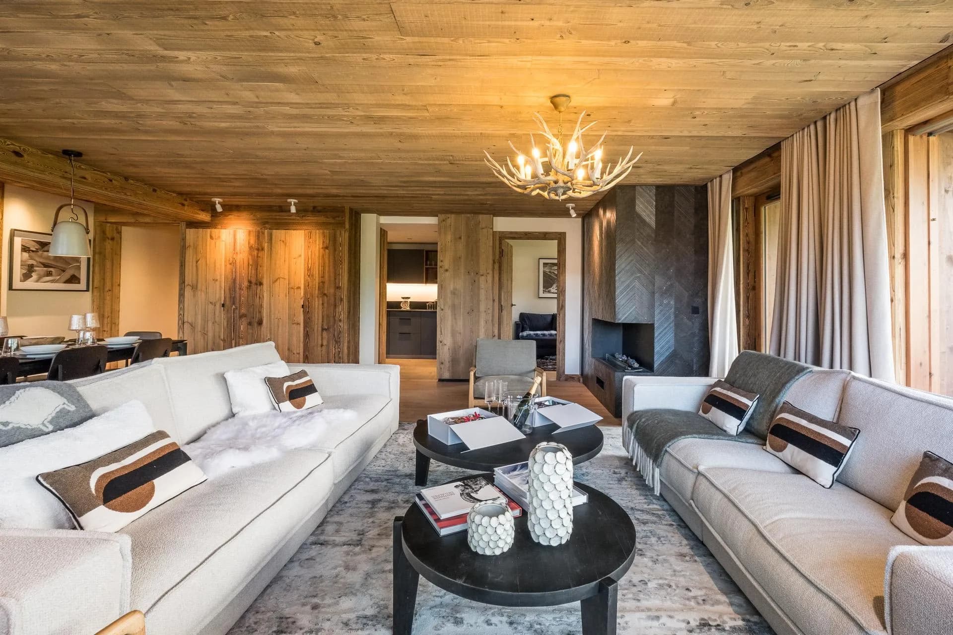 Living room with timber ceiling and stone fireplace