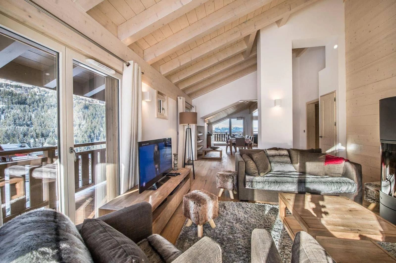 Open-plan living area with a wood stove and terrace access