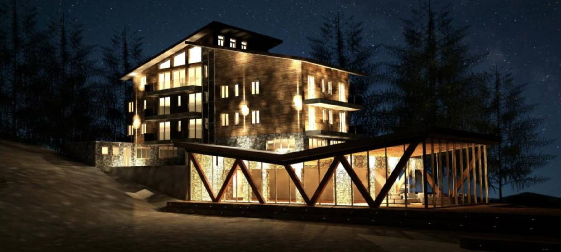 Chalet exterior at night with multiple private balconies and glass-walled lounge