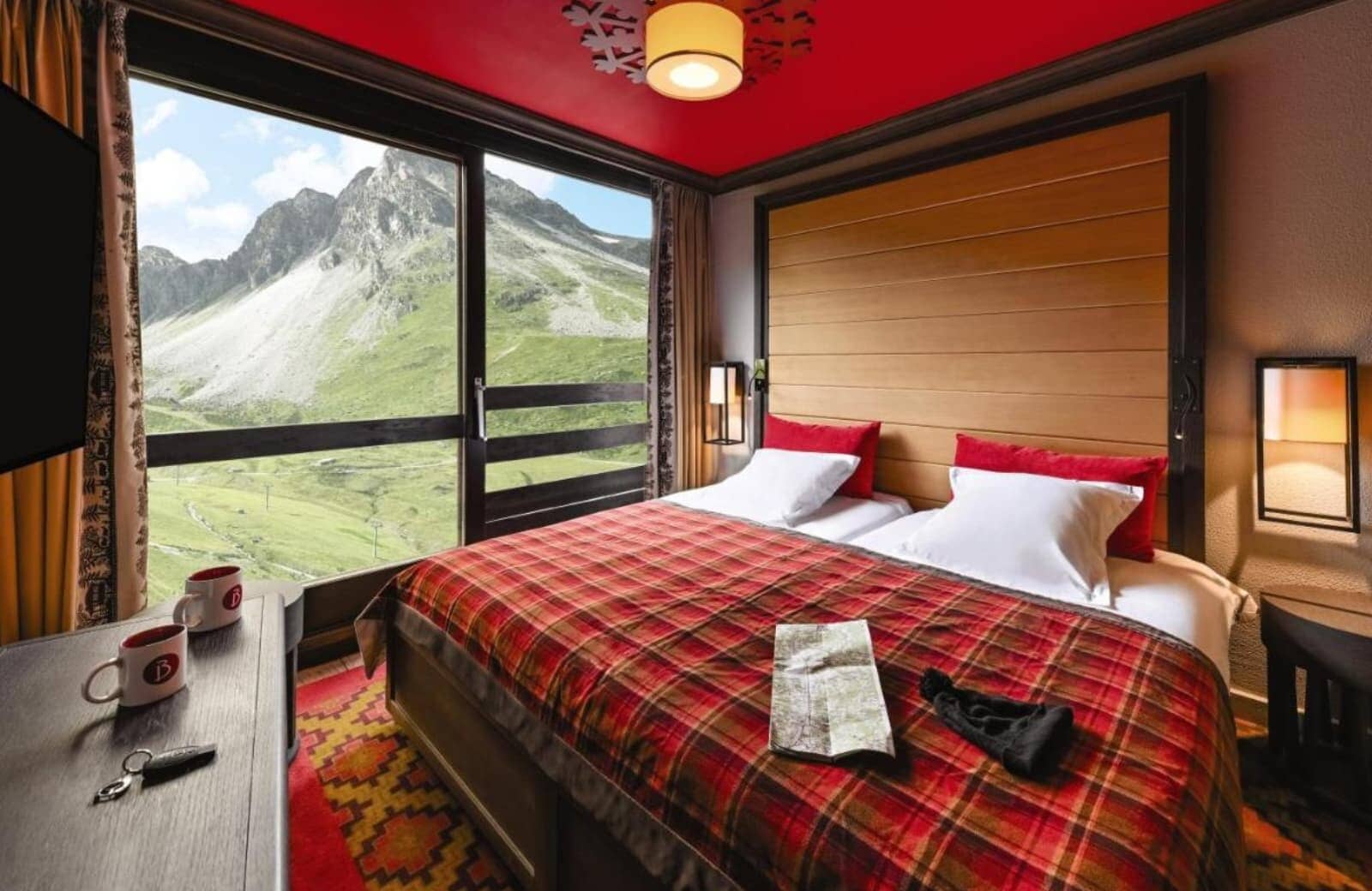 Guest bedroom with king bed and floor-to-ceiling mountain views