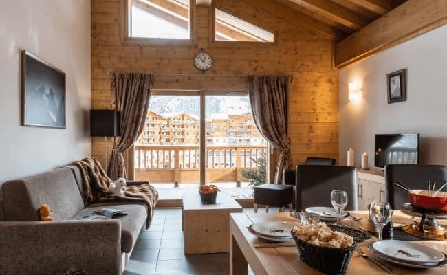 Living and dining area with balcony and resort views