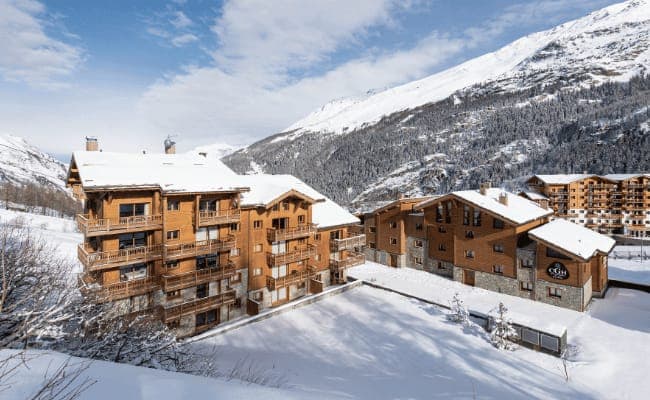 Chalet exterior with private balconies and mountain backdrop
