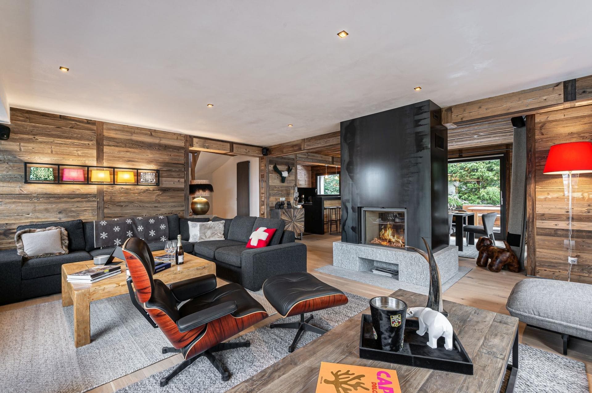 Open-plan living room with sectional sofa and wood fireplace