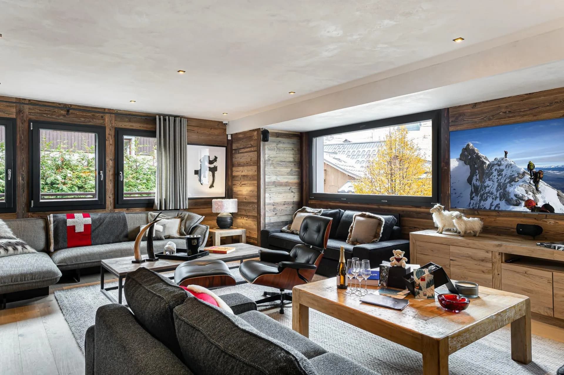 Reading lounge with armchairs, timber walls and large windows