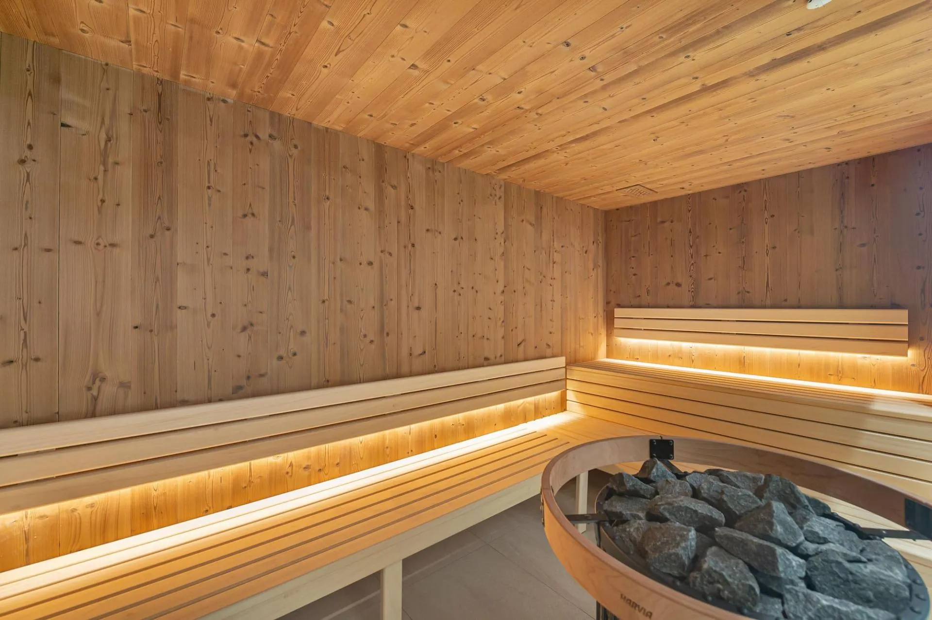 Cedar sauna with electric heater and multi-level bench seating